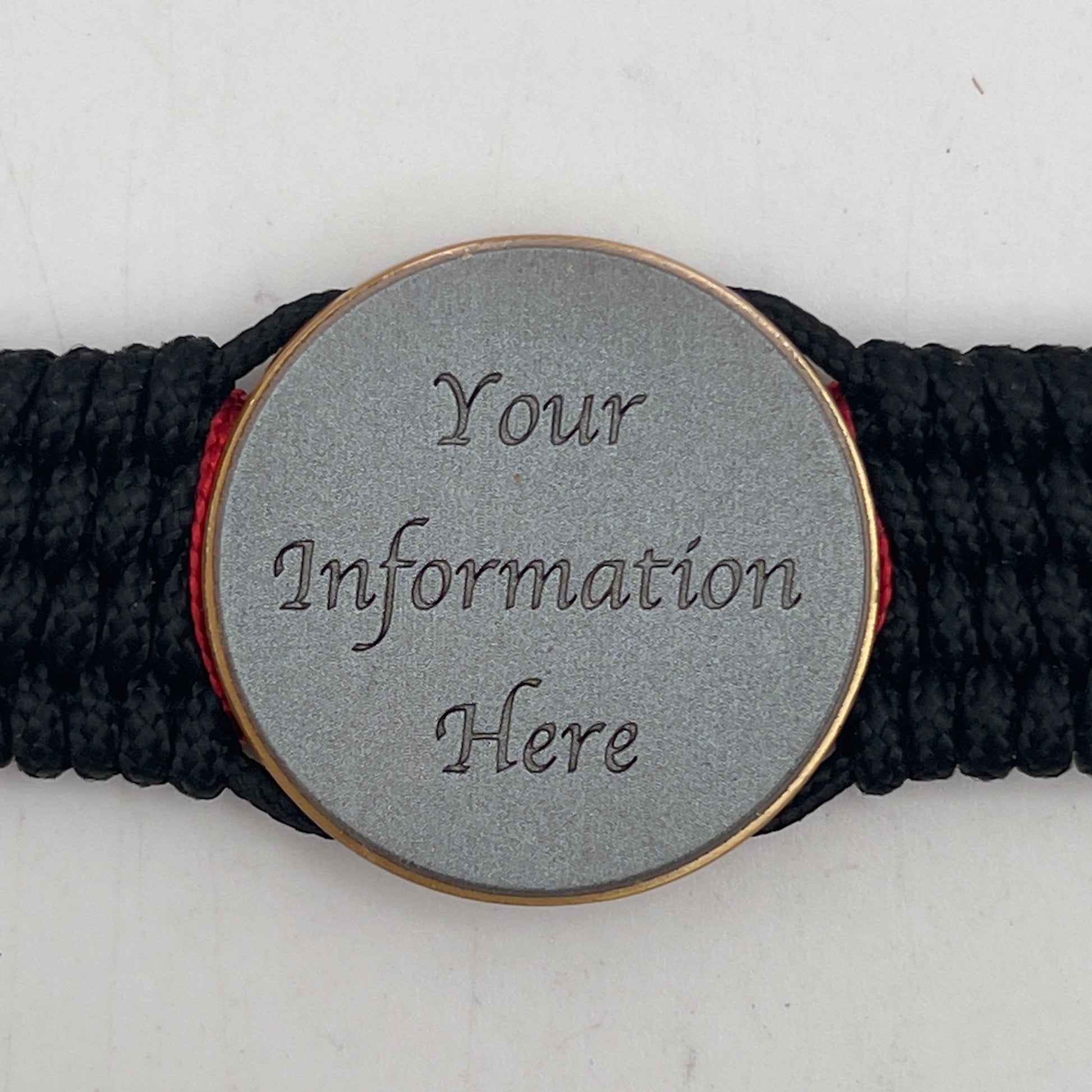 Thin, medium width, flexible and comfortable braided United States Marine Corps bracelet featuring a 24K antique gold plated USMC Eagle Globe and Anchor medallion, a black Cobra style tactical buckle and woven with black Type-1 paracord and Imperial Red and Gold nano cord.