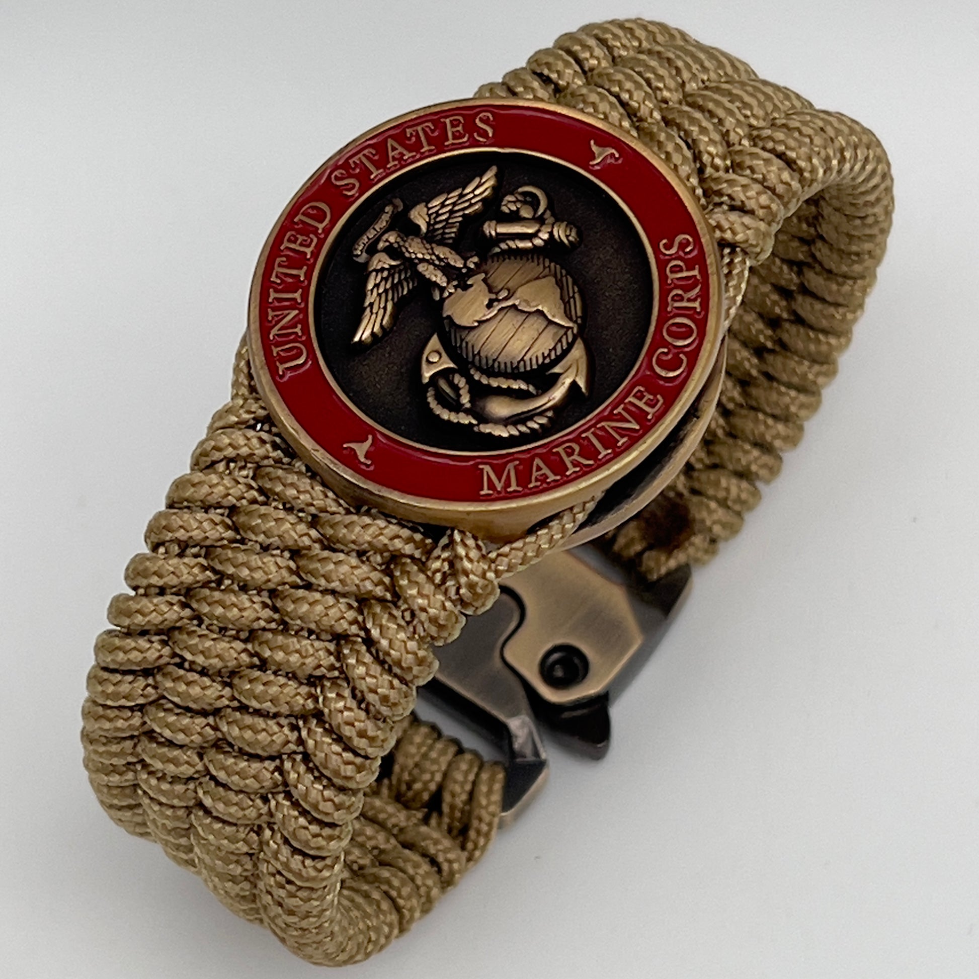 Thin, wide, flexible and comfortable braided United States Marine Corps bracelet featuring a 24K antique gold plated USMC Eagle Globe and Anchor medallion, a gold Cobra style tactical buckle and woven with gold Type-1 paracord.