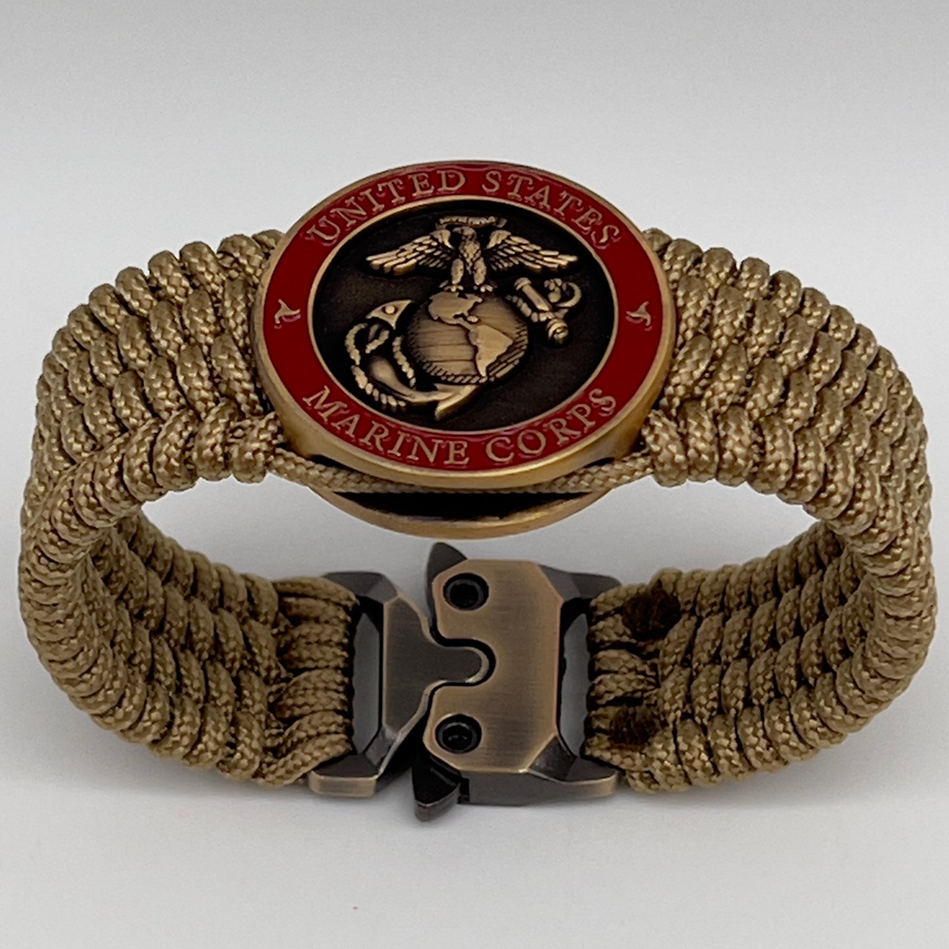 Thin, wide, flexible and comfortable braided United States Marine Corps bracelet featuring a 24K antique gold plated USMC Eagle Globe and Anchor medallion, a gold Cobra style tactical buckle and woven with gold Type-1 paracord.