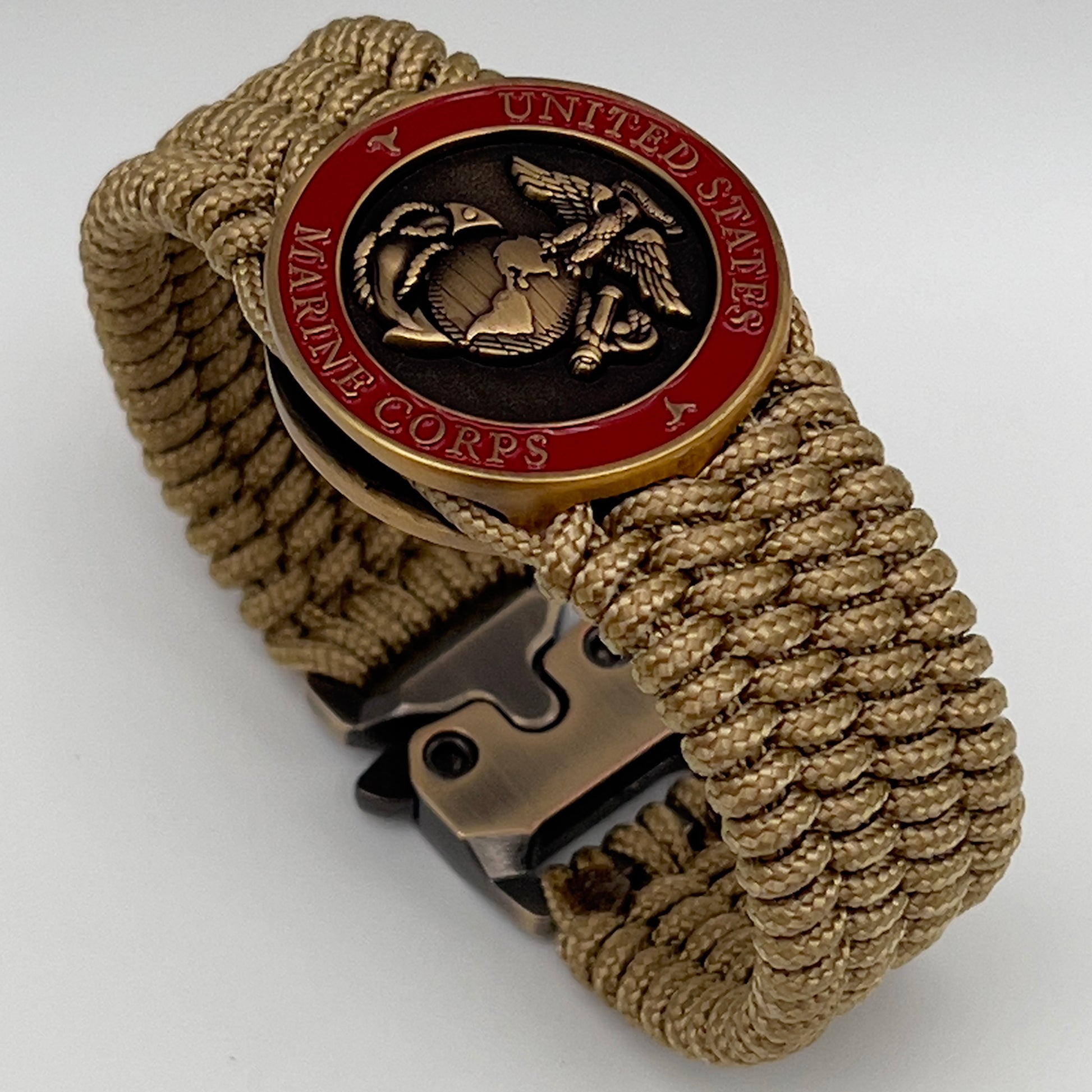 Thin, wide, flexible and comfortable braided United States Marine Corps bracelet featuring a 24K antique gold plated USMC Eagle Globe and Anchor medallion, a gold Cobra style tactical buckle and woven with gold Type-1 paracord.