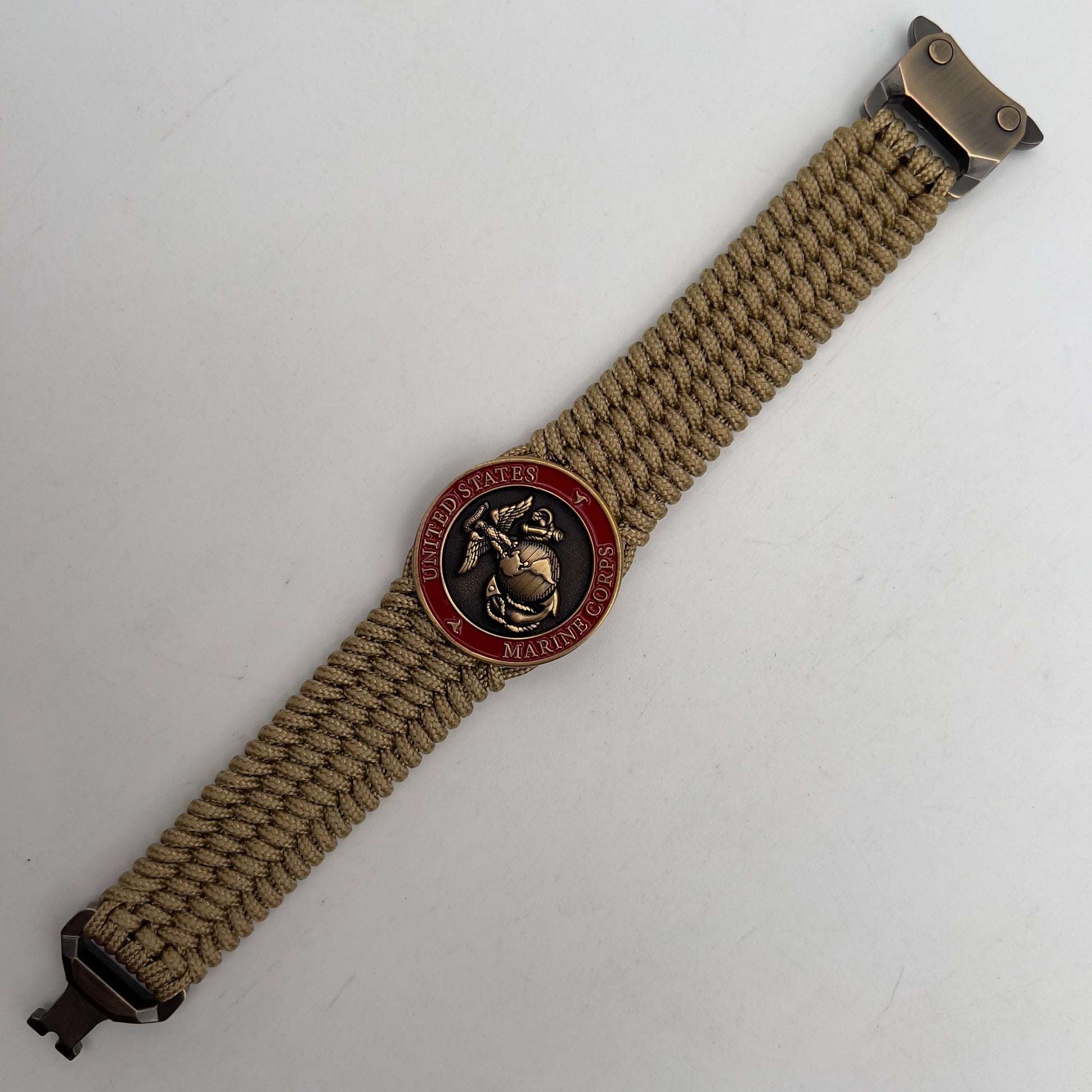 Thin, wide, flexible and comfortable braided United States Marine Corps bracelet featuring a 24K antique gold plated USMC Eagle Globe and Anchor medallion, a gold Cobra style tactical buckle and woven with gold Type-1 paracord.