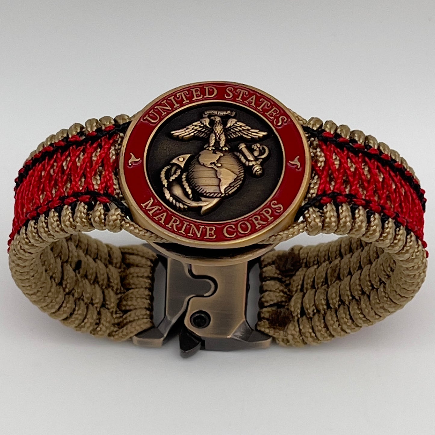 Thin, medium width, flexible and comfortable braided United States Marine Corps bracelet featuring a 24K antique gold plated USMC Eagle Globe and Anchor medallion, a gold Cobra style tactical buckle and woven with gold Type-1 paracord and Imperial Red and Black nano cord.