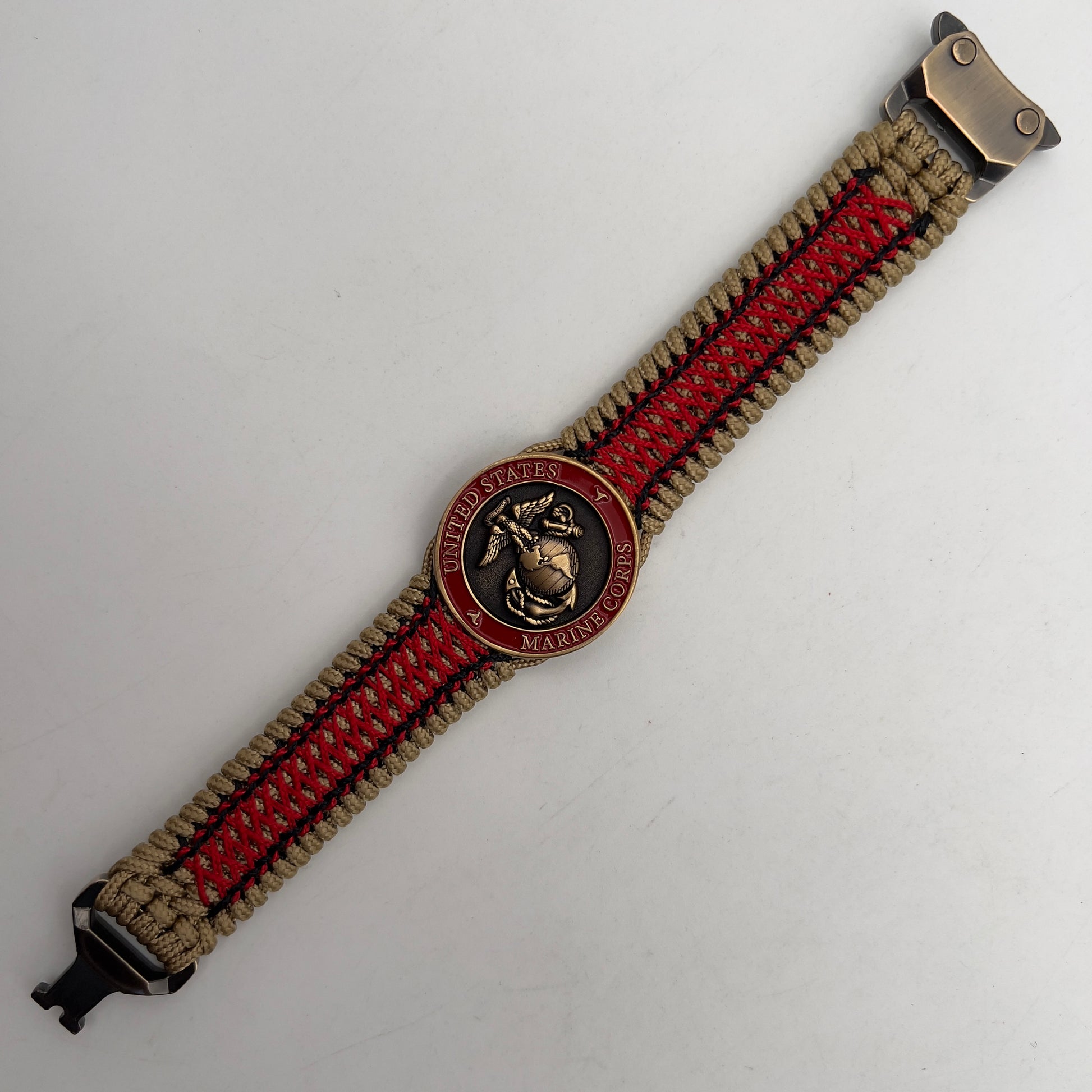 Thin, medium width, flexible and comfortable braided United States Marine Corps bracelet featuring a 24K antique gold plated USMC Eagle Globe and Anchor medallion, a gold Cobra style tactical buckle and woven with gold Type-1 paracord and Imperial Red and Black nano cord.