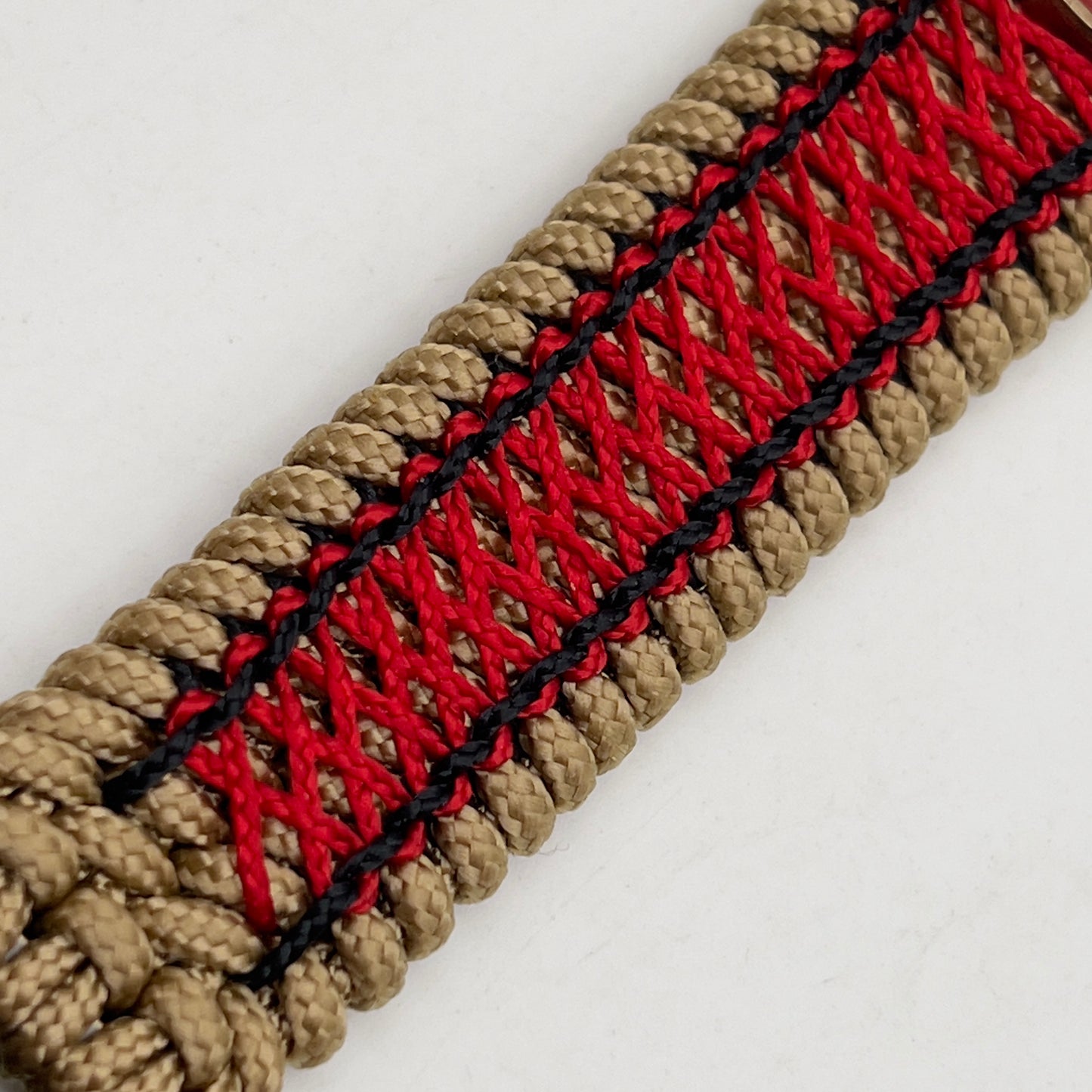 Thin, medium width, flexible and comfortable braided United States Marine Corps bracelet featuring a 24K antique gold plated USMC Eagle Globe and Anchor medallion, a gold Cobra style tactical buckle and woven with gold Type-1 paracord and Imperial Red and Black nano cord.