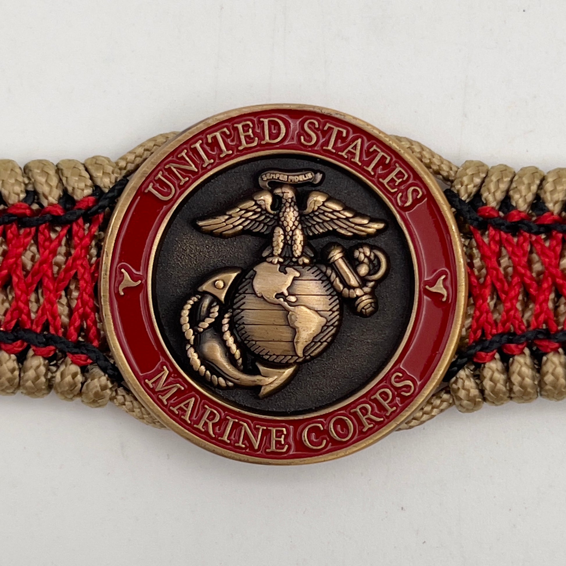 Thin, medium width, flexible and comfortable braided United States Marine Corps bracelet featuring a 24K antique gold plated USMC Eagle Globe and Anchor medallion, a gold Cobra style tactical buckle and woven with gold Type-1 paracord and Imperial Red and Black nano cord.
