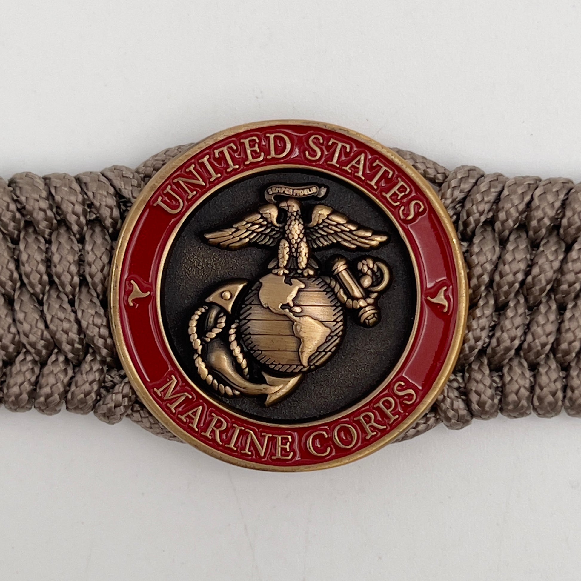 Thin, medium wide, flexible and comfortable braided United States Marine Corps bracelet featuring a 24K antique gold plated USMC Eagle Globe and Anchor medallion, a gold Cobra style tactical buckle and woven with Tan Type-1 paracord.