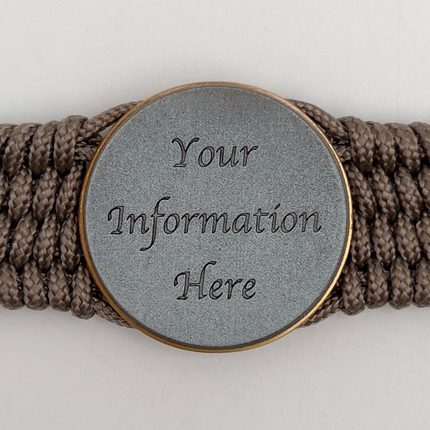 Thin, medium wide, flexible and comfortable braided United States Marine Corps bracelet featuring a 24K antique gold plated USMC Eagle Globe and Anchor medallion, a gold Cobra style tactical buckle and woven with Tan Type-1 paracord.