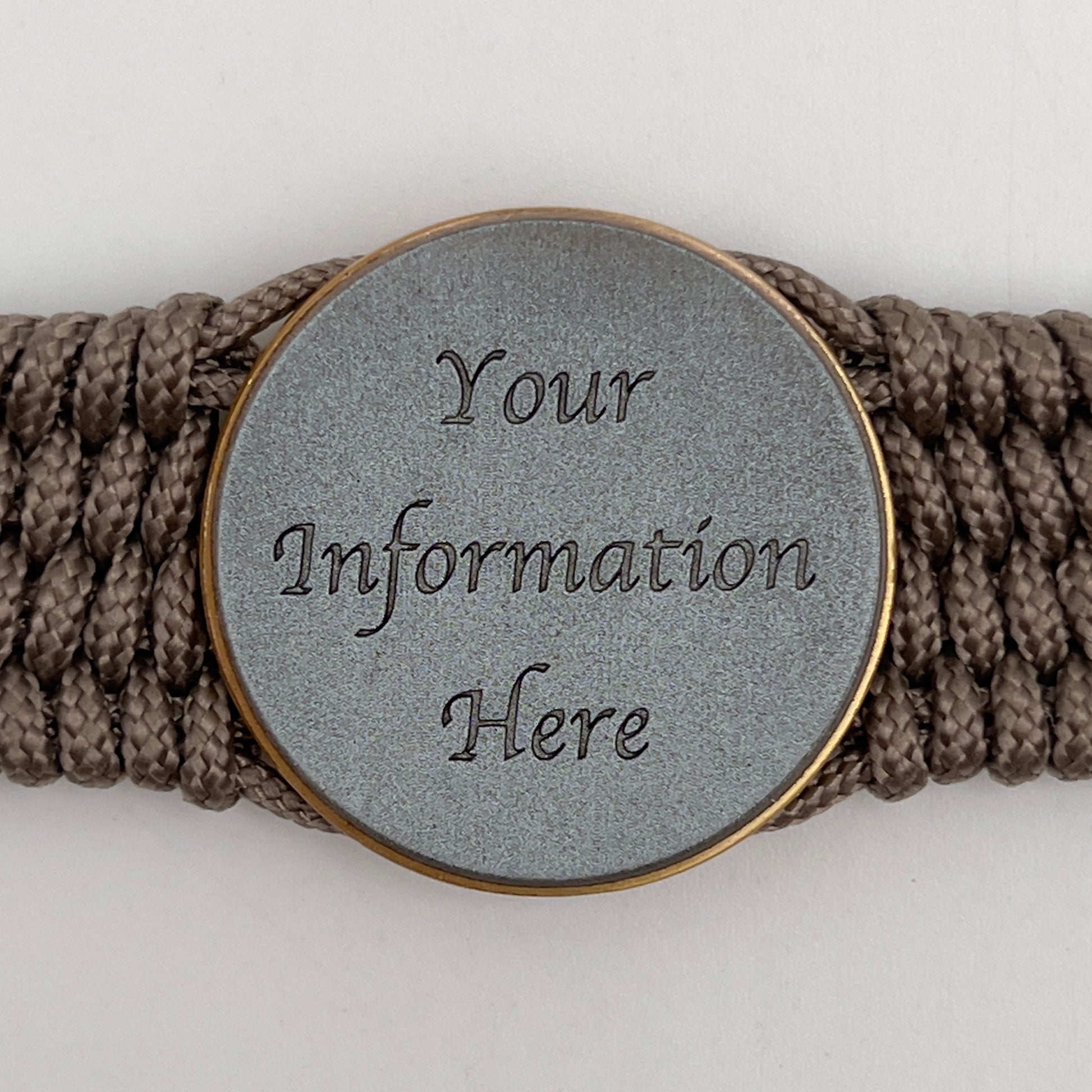 Thin, medium wide, flexible and comfortable braided United States Marine Corps bracelet featuring a 24K antique gold plated USMC Eagle Globe and Anchor medallion, a gold Cobra style tactical buckle and woven with Tan Type-1 paracord.