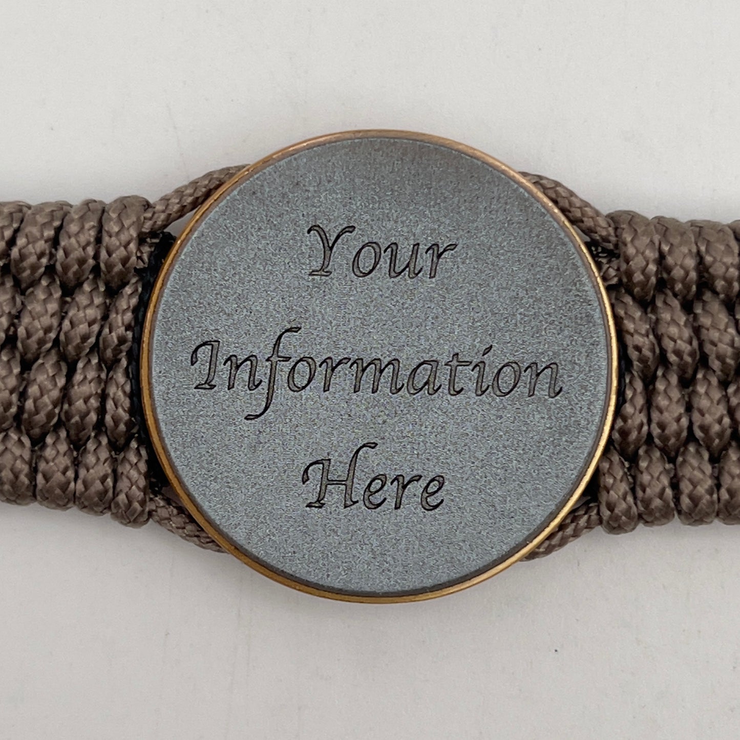 Thin, medium width, flexible and comfortable braided United States Marine Corps bracelet featuring a 24K antique gold plated USMC Eagle Globe and Anchor medallion, a gold Cobra style tactical buckle and woven with Tan Type-1 paracord and Imperial Red and Black nano cord.