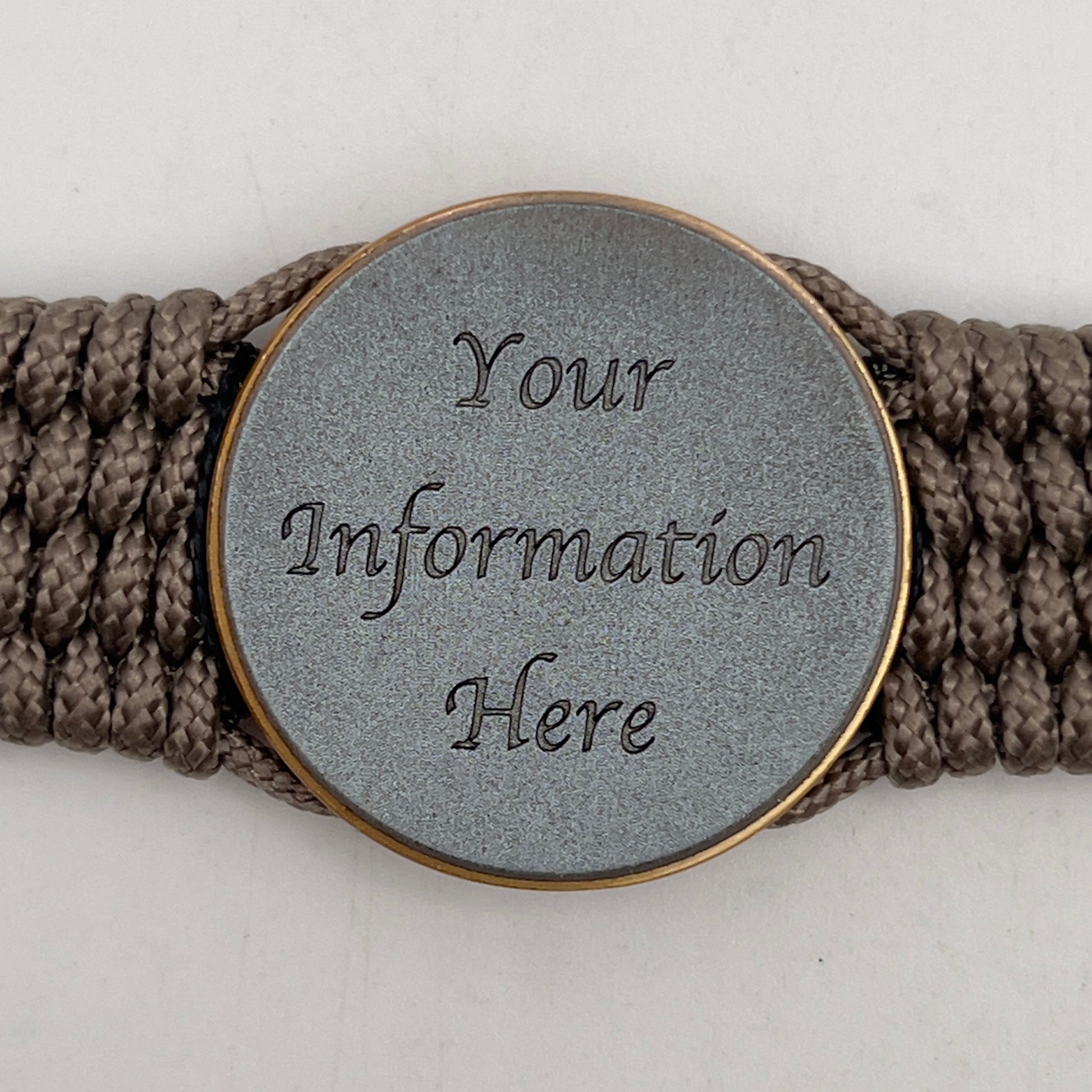 Thin, medium width, flexible and comfortable braided United States Marine Corps bracelet featuring a 24K antique gold plated USMC Eagle Globe and Anchor medallion, a gold Cobra style tactical buckle and woven with Tan Type-1 paracord and Imperial Red and Black nano cord.