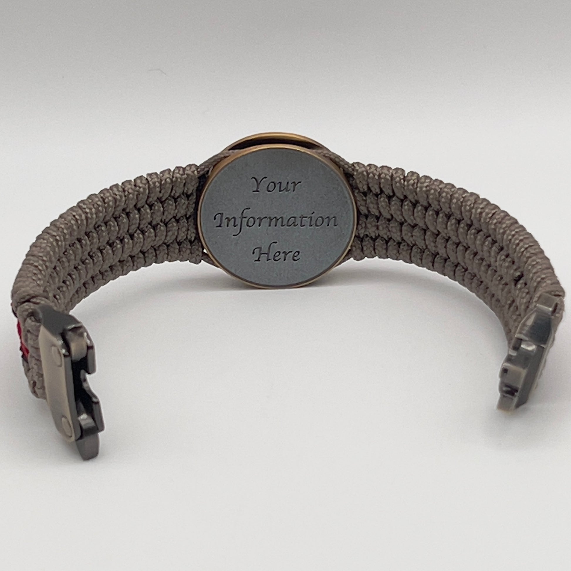 Thin, medium width, flexible and comfortable braided United States Marine Corps bracelet featuring a 24K antique gold plated USMC Eagle Globe and Anchor medallion, a gold Cobra style tactical buckle and woven with Tan Type-1 paracord and Imperial Red and Black nano cord.