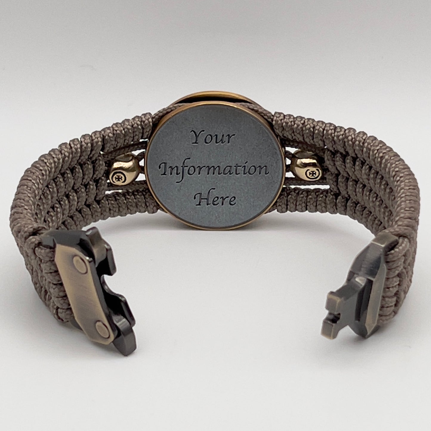 Thin, medium width, flexible and comfortable braided United States Marine Corps bracelet featuring a 24K antique gold plated USMC officer Eagle Globe and Anchor medallion, two gold plated skulls, a gold Cobra style tactical buckle and woven with tan Type-1 paracord.