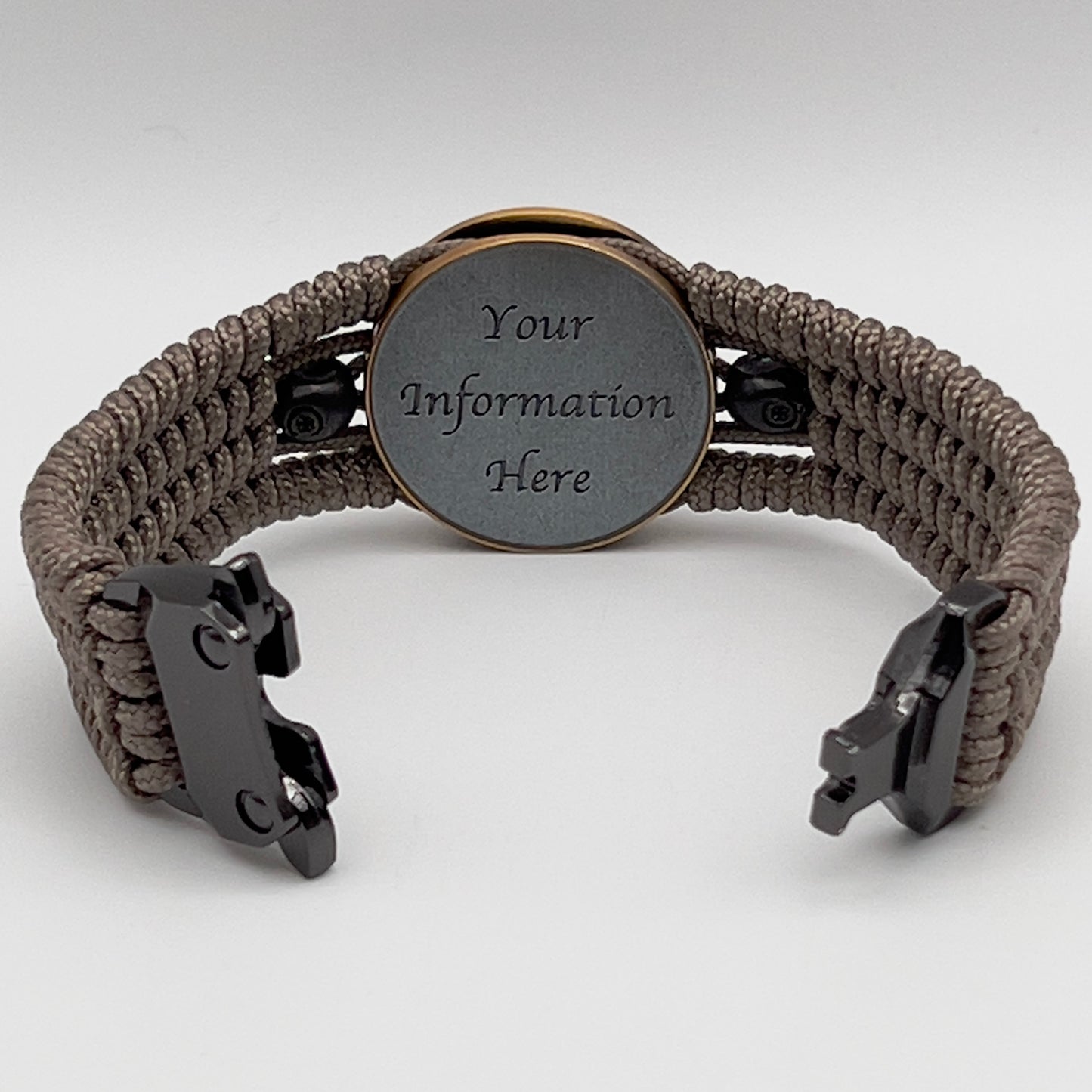 Thin, medium width, flexible and comfortable braided United States Marine Corps bracelet featuring a 24K antique gold plated USMC officer Eagle Globe and Anchor medallion, two black skulls, a black Cobra style tactical buckle and woven with tan Type-1 paracord.