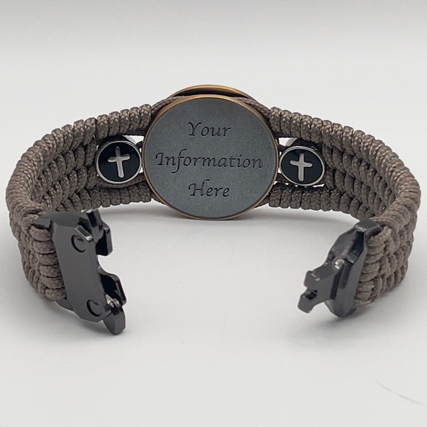 Thin, medium width, flexible and comfortable braided United States Marine Corps bracelet featuring a 24K antique gold plated USMC officer Eagle Globe and Anchor medallion, two Christian crosses, a black Cobra style tactical buckle and woven with Tan Type-1 paracord.