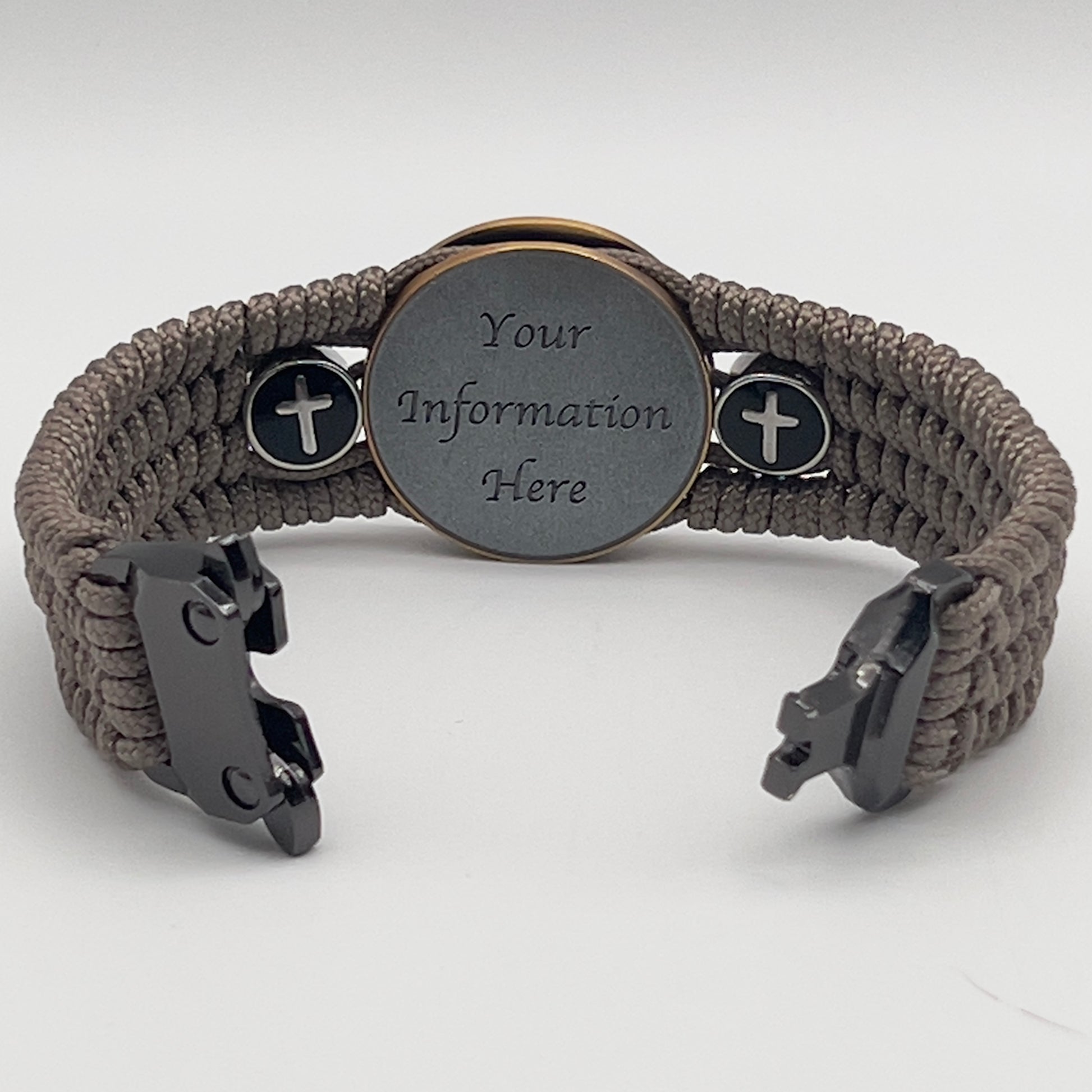 Thin, medium width, flexible and comfortable braided United States Marine Corps bracelet featuring a 24K antique gold plated USMC officer Eagle Globe and Anchor medallion, two Christian crosses, a black Cobra style tactical buckle and woven with Tan Type-1 paracord.