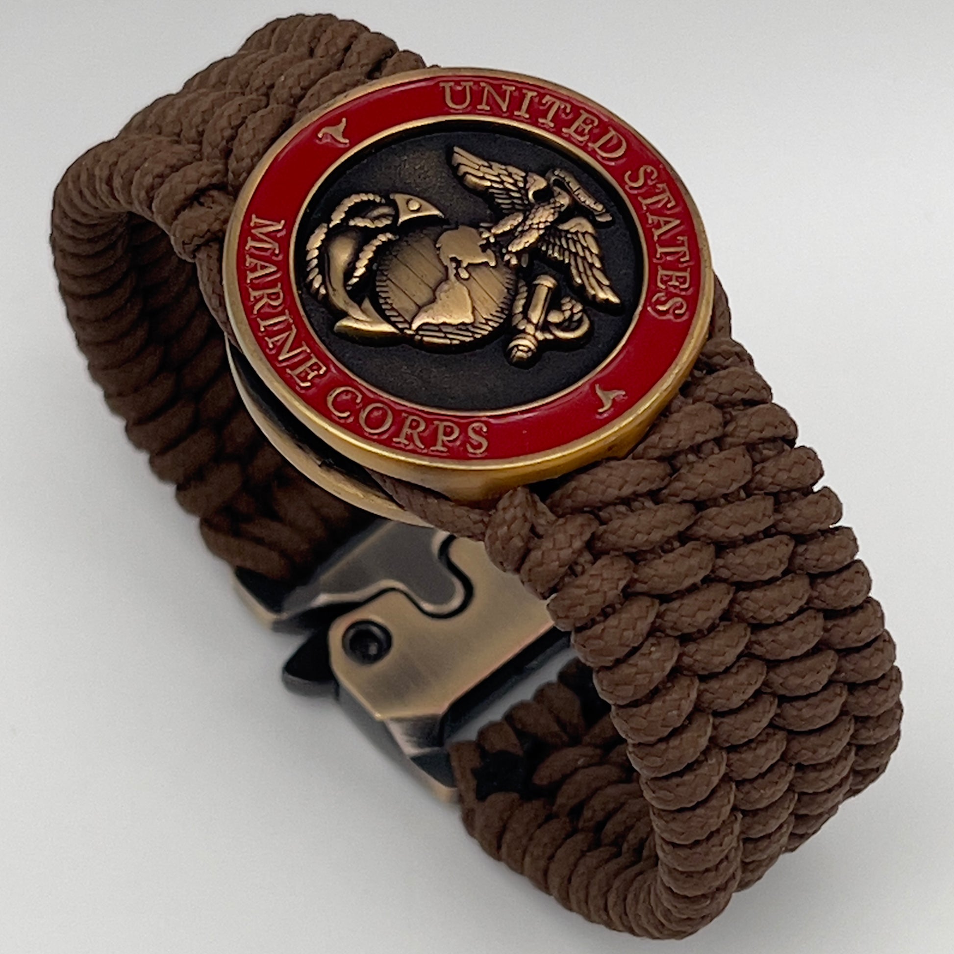 Thin, medium wide, flexible and comfortable braided United States Marine Corps bracelet featuring a 24K antique gold plated USMC Eagle Globe and Anchor medallion, a gold Cobra style tactical buckle and woven with Coyote Brown Type-1 paracord.
