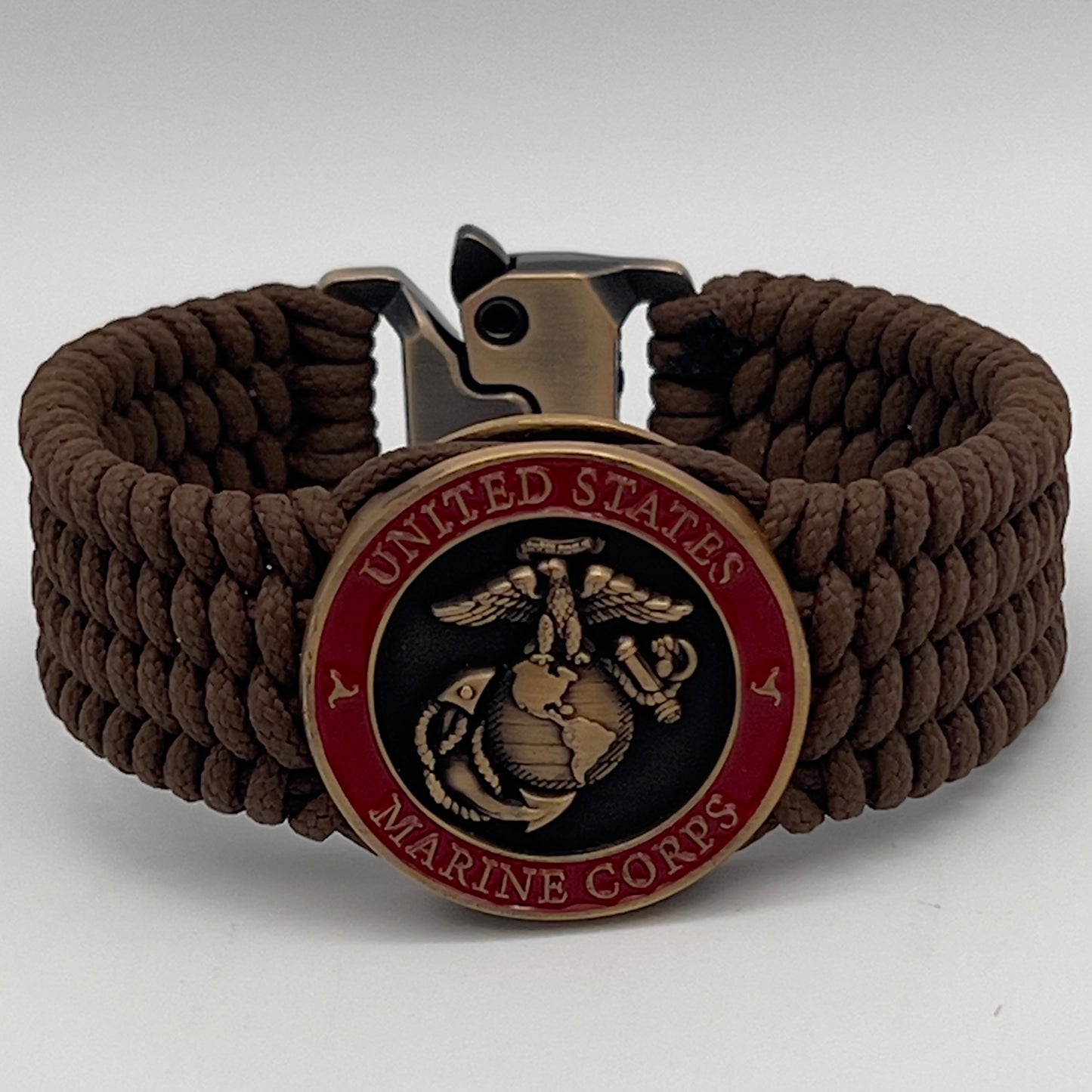 Thin, medium wide, flexible and comfortable braided United States Marine Corps bracelet featuring a 24K antique gold plated USMC Eagle Globe and Anchor medallion, a gold Cobra style tactical buckle and woven with Coyote Brown Type-1 paracord.
