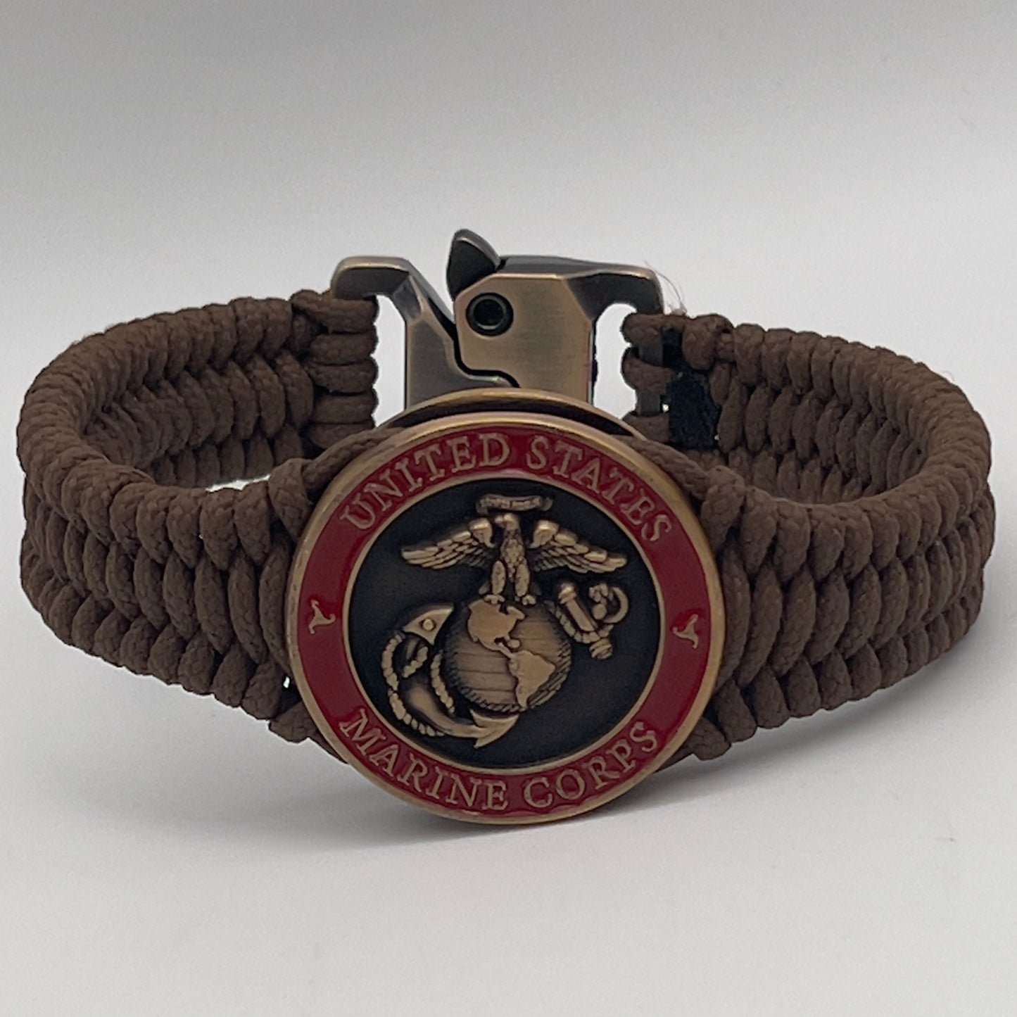 Thin, narrow, flexible and comfortable braided United States Marine Corps bracelet featuring a 24K antique gold plated USMC Eagle Globe and Anchor medallion, a gold Cobra style tactical buckle and woven with Coyote Brown Type-1 paracord.