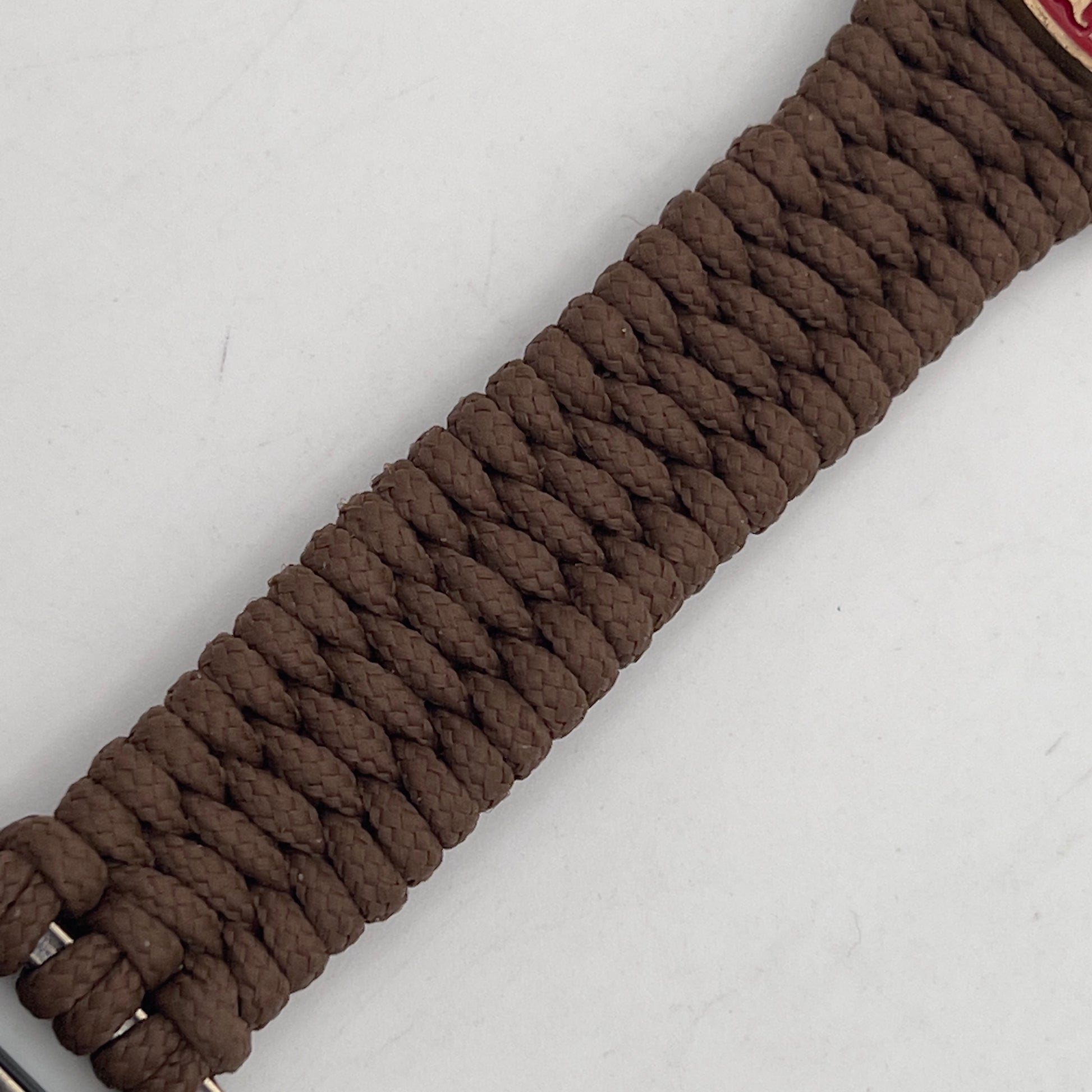 Thin, narrow, flexible and comfortable braided United States Marine Corps bracelet featuring a 24K antique gold plated USMC Eagle Globe and Anchor medallion, a gold Cobra style tactical buckle and woven with Coyote Brown Type-1 paracord.