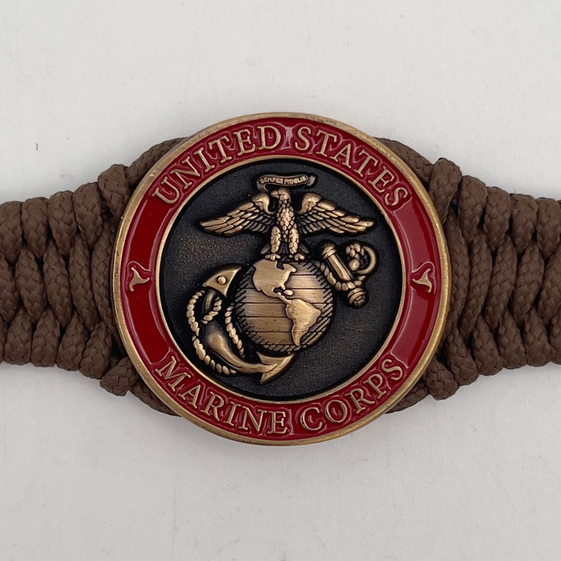 Thin, narrow, flexible and comfortable braided United States Marine Corps bracelet featuring a 24K antique gold plated USMC Eagle Globe and Anchor medallion, a gold Cobra style tactical buckle and woven with Coyote Brown Type-1 paracord.