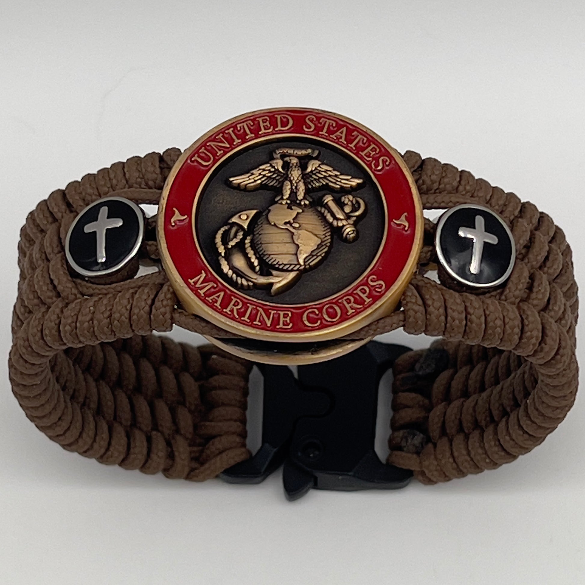 Thin, medium width, flexible and comfortable braided United States Marine Corps bracelet featuring a 24K antique gold plated USMC officer Eagle Globe and Anchor medallion, two Christian crosses, a black Cobra style tactical buckle and woven with Coyote Brown Type-1 paracord.