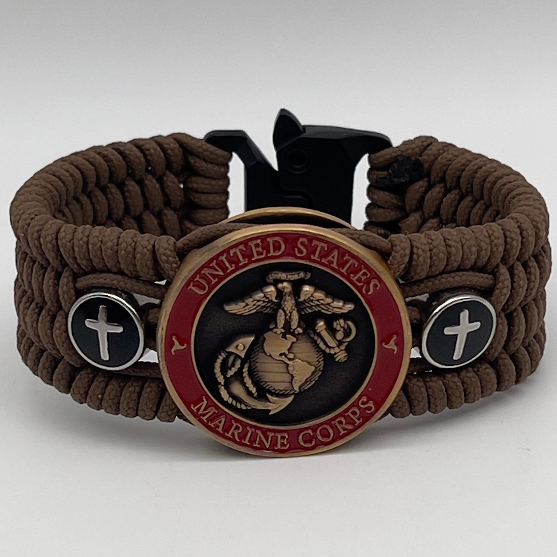 Thin, medium width, flexible and comfortable braided United States Marine Corps bracelet featuring a 24K antique gold plated USMC officer Eagle Globe and Anchor medallion, two Christian crosses, a black Cobra style tactical buckle and woven with Coyote Brown Type-1 paracord.