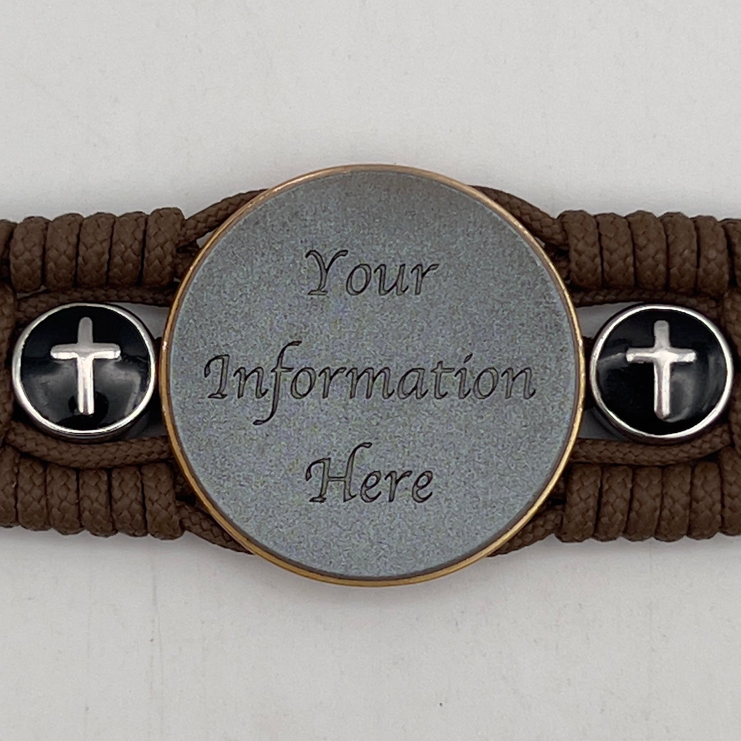 Thin, medium width, flexible and comfortable braided United States Marine Corps bracelet featuring a 24K antique gold plated USMC officer Eagle Globe and Anchor medallion, two Christian crosses, a black Cobra style tactical buckle and woven with Coyote Brown Type-1 paracord.