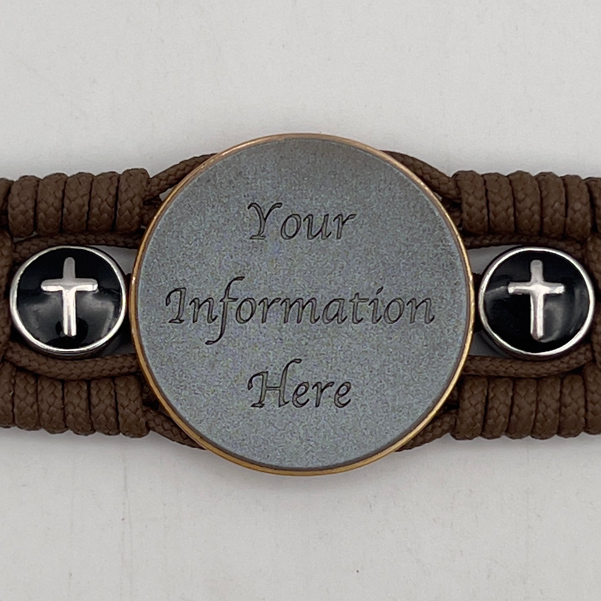 Thin, medium width, flexible and comfortable braided United States Marine Corps bracelet featuring a 24K antique gold plated USMC officer Eagle Globe and Anchor medallion, two Christian crosses, a black Cobra style tactical buckle and woven with Coyote Brown Type-1 paracord.