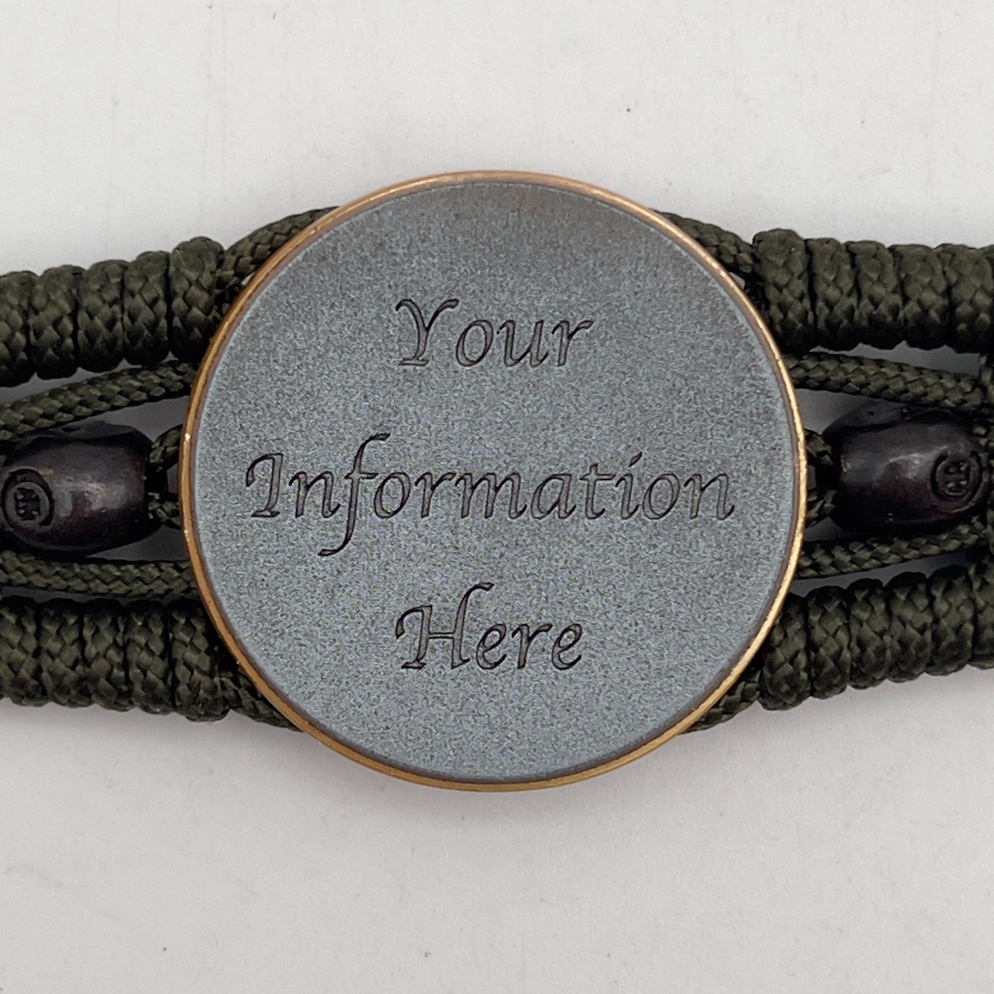 Thin, medium width, flexible and comfortable braided United States Marine Corps bracelet featuring a 24K antique gold plated USMC officer Eagle Globe and Anchor medallion, two black skulls, a black Cobra style tactical buckle and woven with Olive Drab Type-1 paracord.