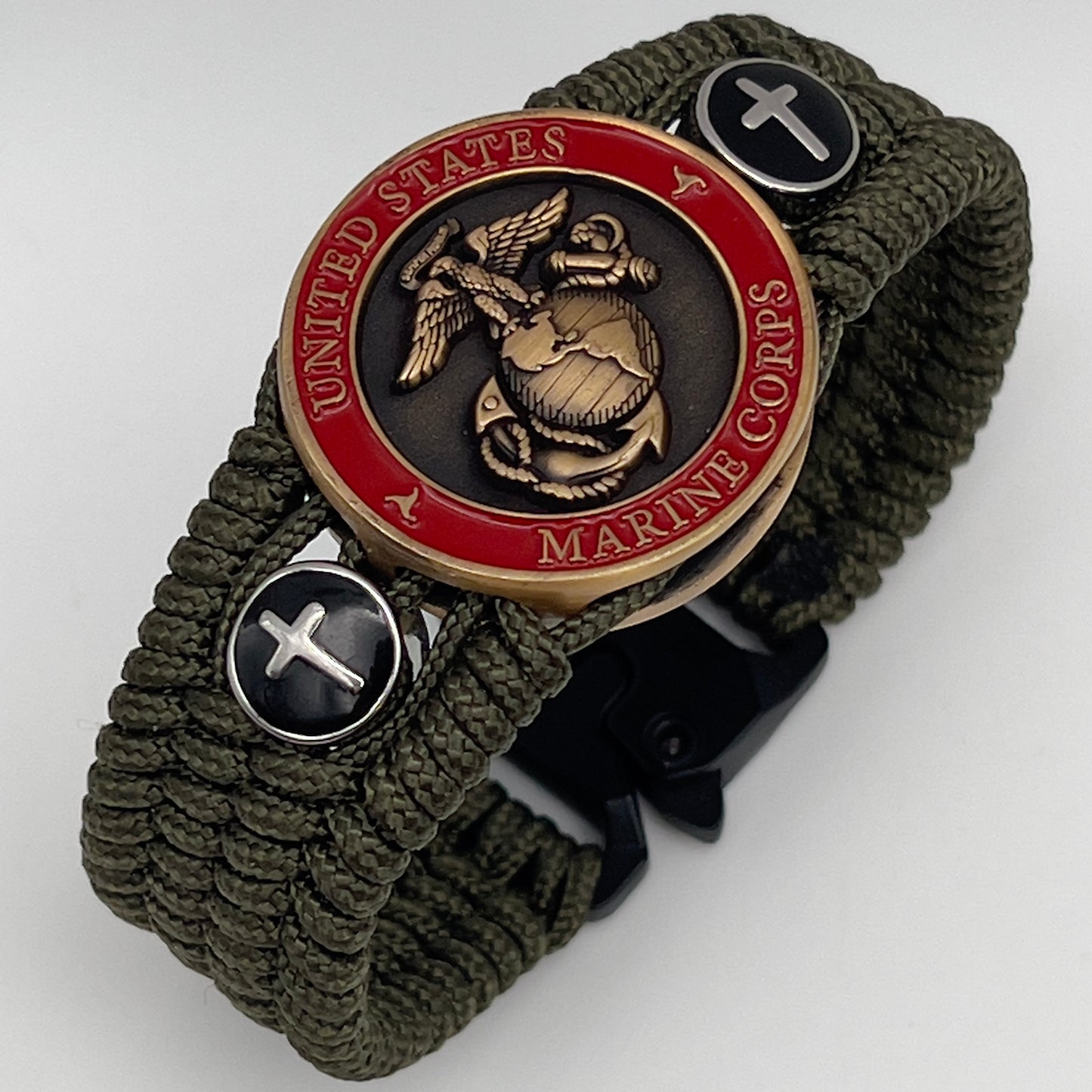 Thin, medium width, flexible and comfortable braided United States Marine Corps bracelet featuring a 24K antique gold plated USMC officer Eagle Globe and Anchor medallion, two Christian crosses, a black Cobra style tactical buckle and woven with Olive Drab Type-1 paracord.