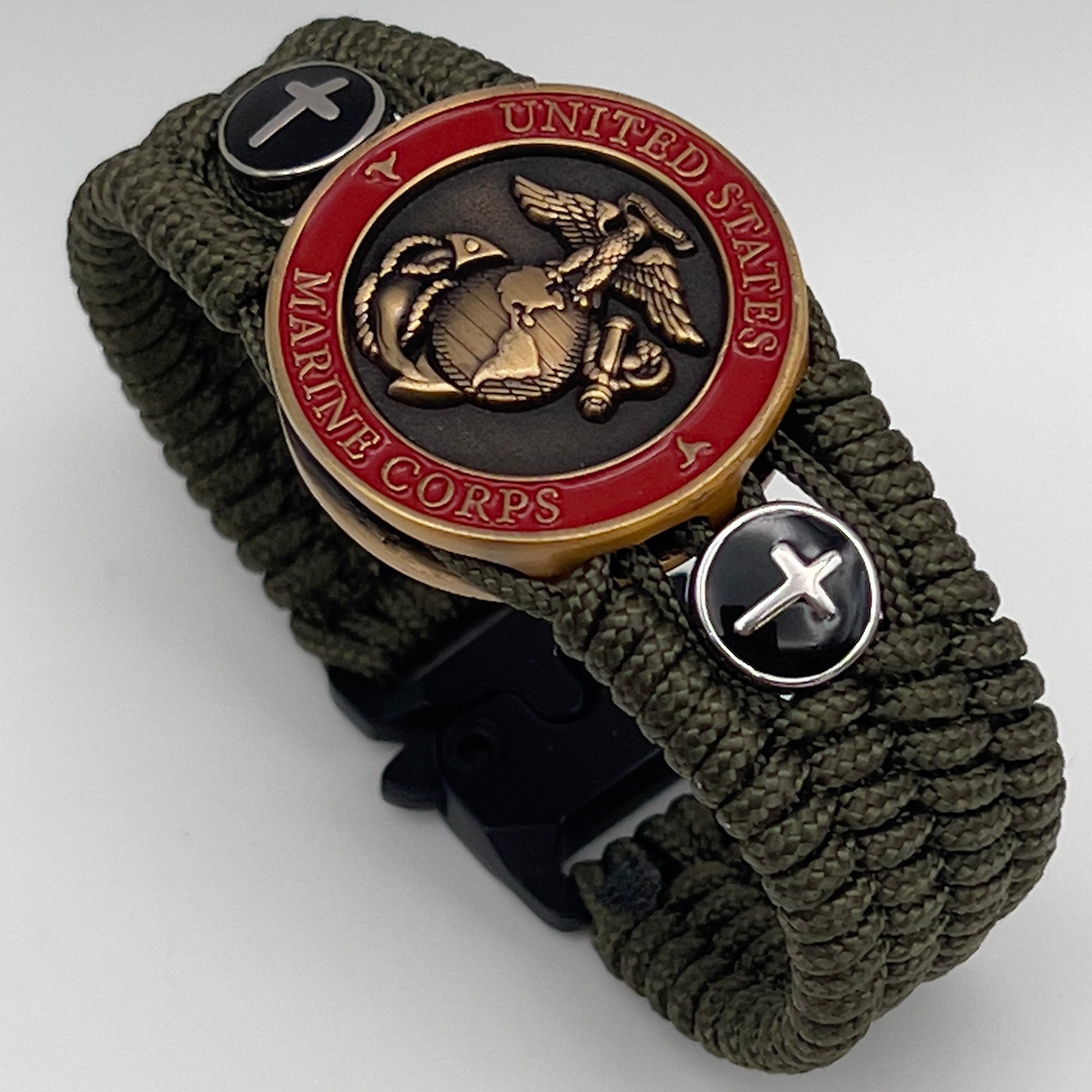 Thin, medium width, flexible and comfortable braided United States Marine Corps bracelet featuring a 24K antique gold plated USMC officer Eagle Globe and Anchor medallion, two Christian crosses, a black Cobra style tactical buckle and woven with Olive Drab Type-1 paracord.