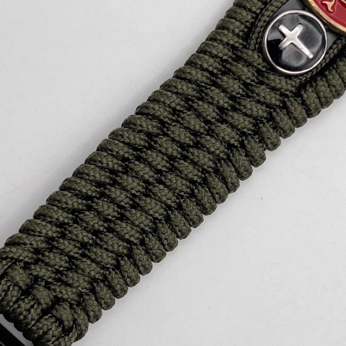 Thin, medium width, flexible and comfortable braided United States Marine Corps bracelet featuring a 24K antique gold plated USMC officer Eagle Globe and Anchor medallion, two Christian crosses, a black Cobra style tactical buckle and woven with Olive Drab Type-1 paracord.