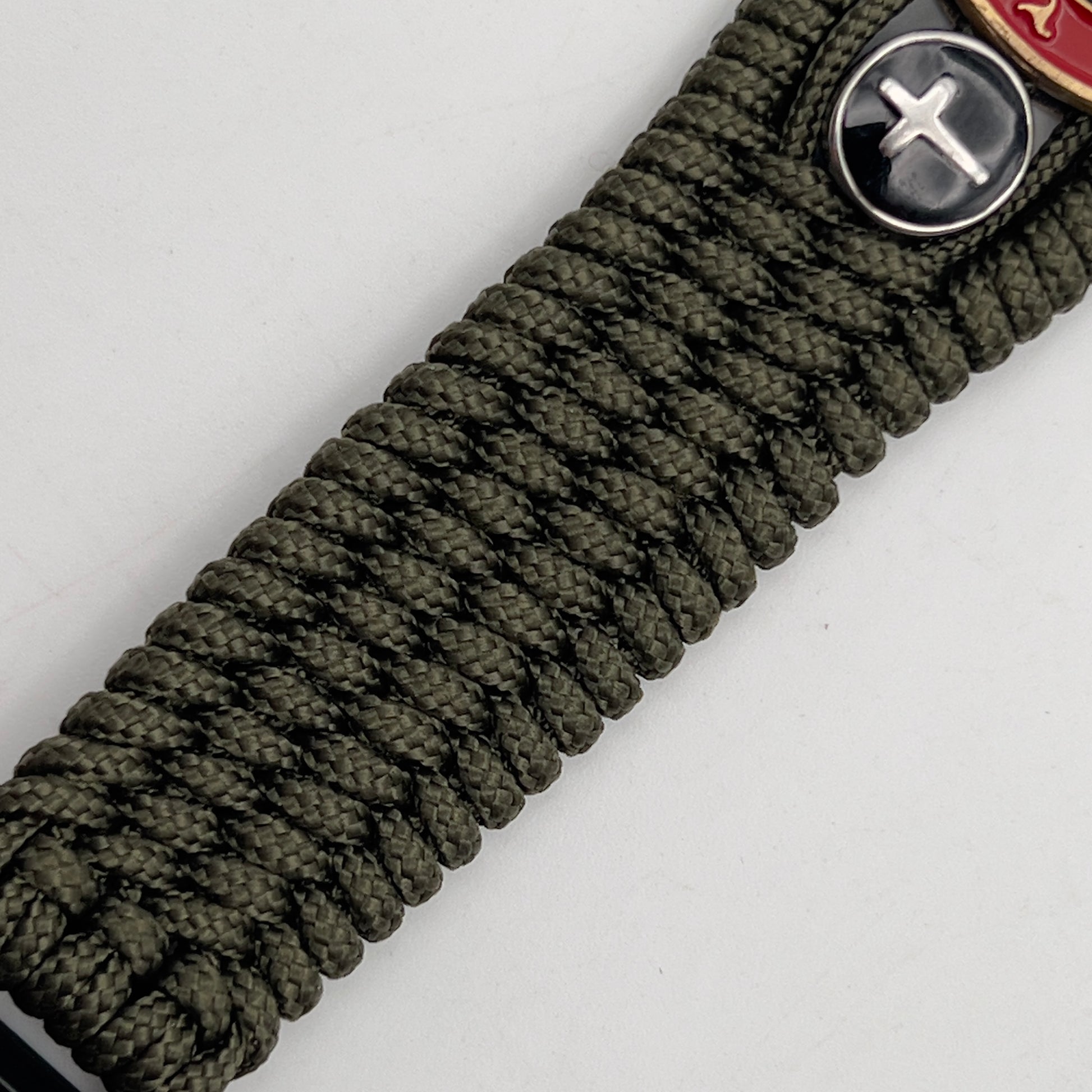 Thin, medium width, flexible and comfortable braided United States Marine Corps bracelet featuring a 24K antique gold plated USMC officer Eagle Globe and Anchor medallion, two Christian crosses, a black Cobra style tactical buckle and woven with Olive Drab Type-1 paracord.