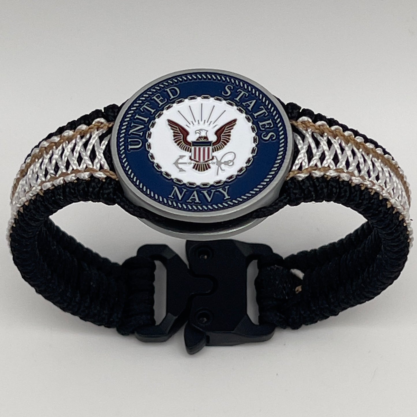 Thin, narrow, flexible and comfortable braided United States Marine Corps bracelet featuring an antique silver plated United States Navy medallion, a black Cobra style tactical buckle and woven with black Type-1 paracord and Gold adn White nano cord.