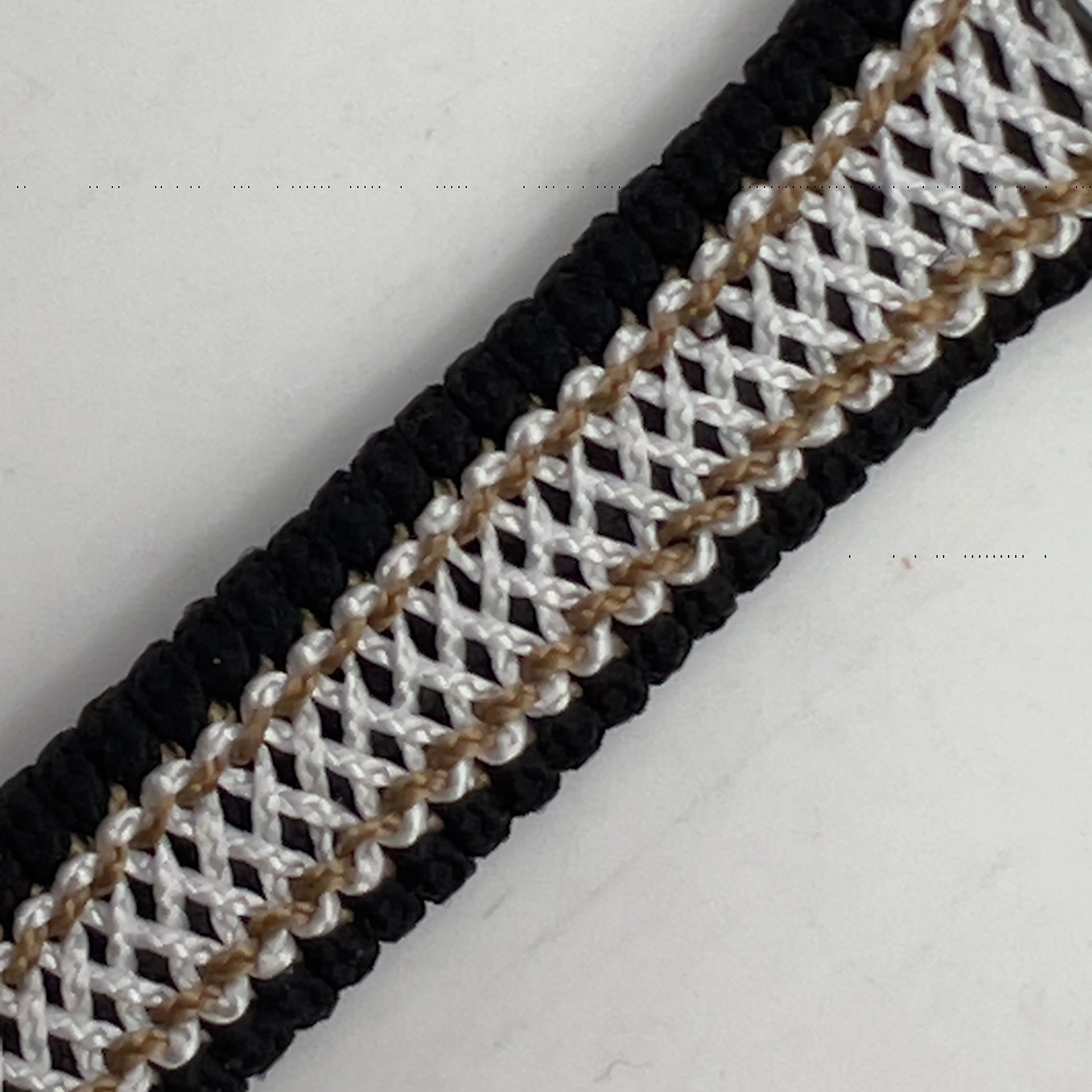 Thin, narrow, flexible and comfortable braided United States Marine Corps bracelet featuring an antique silver plated United States Navy medallion, a black Cobra style tactical buckle and woven with black Type-1 paracord and Gold adn White nano cord.