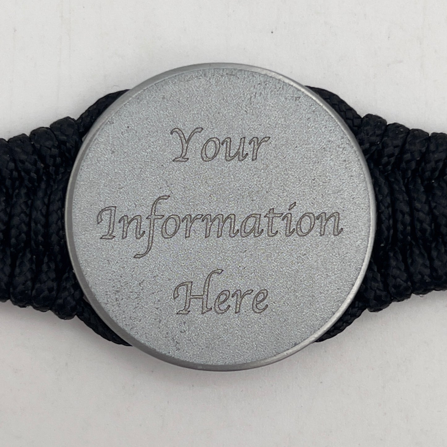 Thin, narrow, flexible and comfortable braided United States Marine Corps bracelet featuring an antique silver plated United States Navy medallion, a black Cobra style tactical buckle and woven with black Type-1 paracord and Gold adn White nano cord.