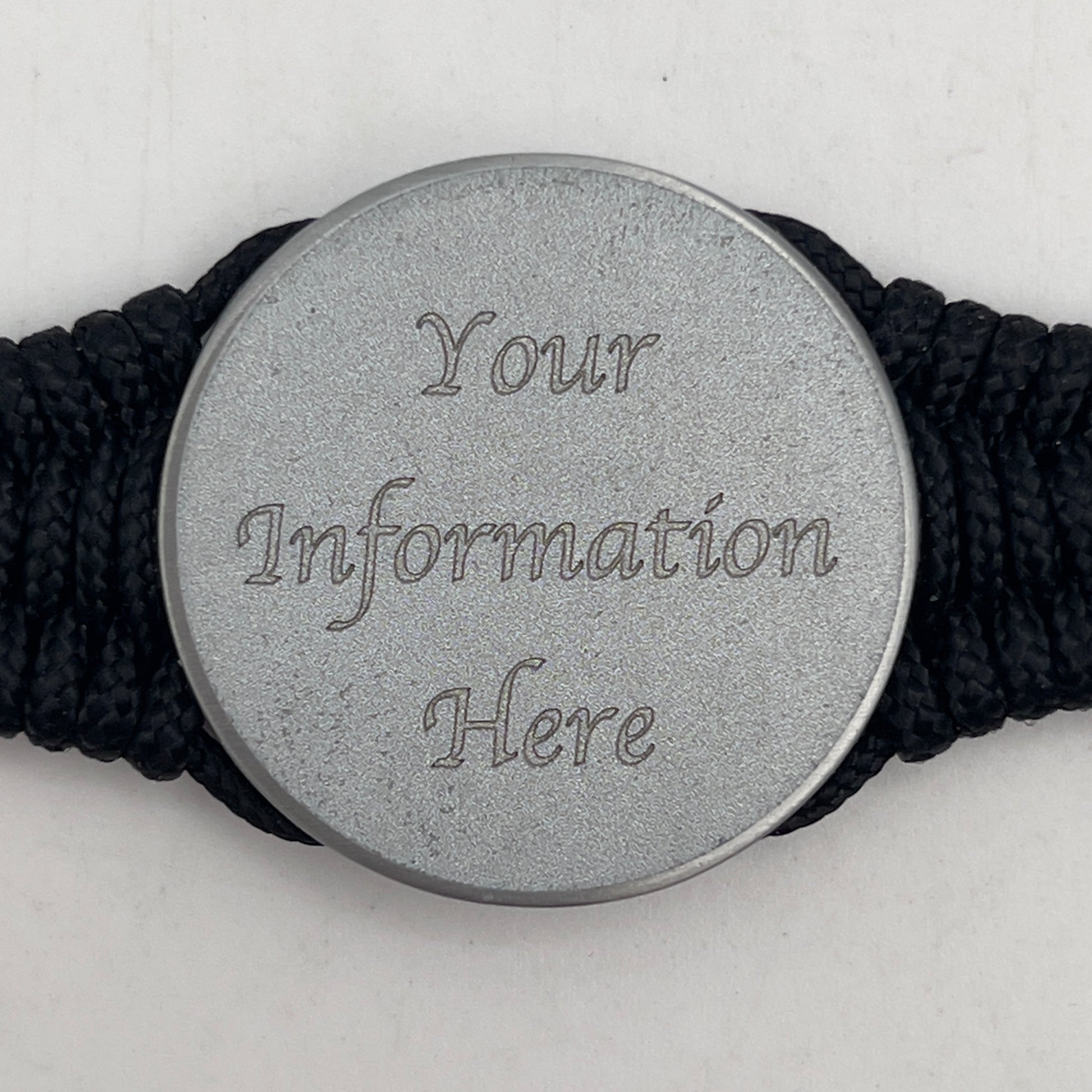 Thin, narrow, flexible and comfortable braided United States Marine Corps bracelet featuring an antique silver plated United States Navy medallion, a black Cobra style tactical buckle and woven with black Type-1 paracord and Gold adn White nano cord.