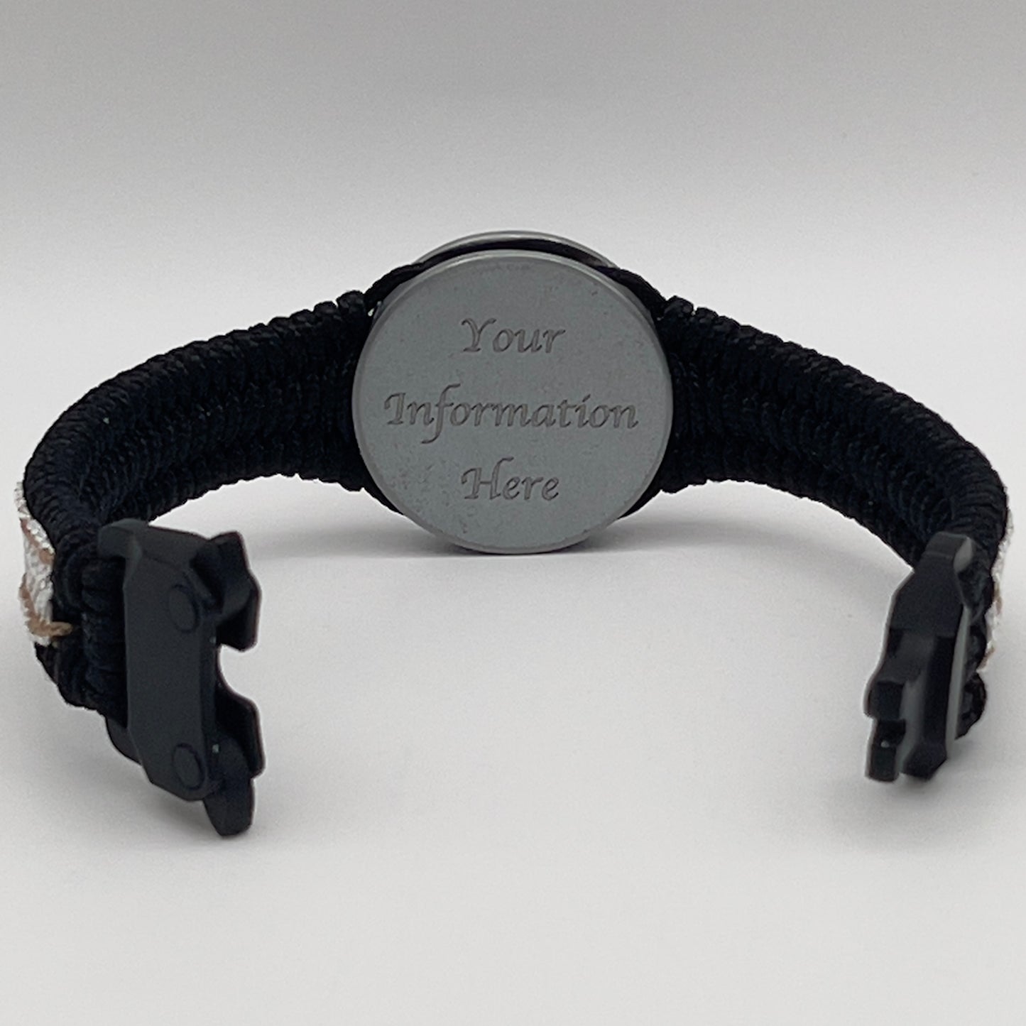 Thin, narrow, flexible and comfortable braided United States Marine Corps bracelet featuring an antique silver plated United States Navy medallion, a black Cobra style tactical buckle and woven with black Type-1 paracord and Gold adn White nano cord.