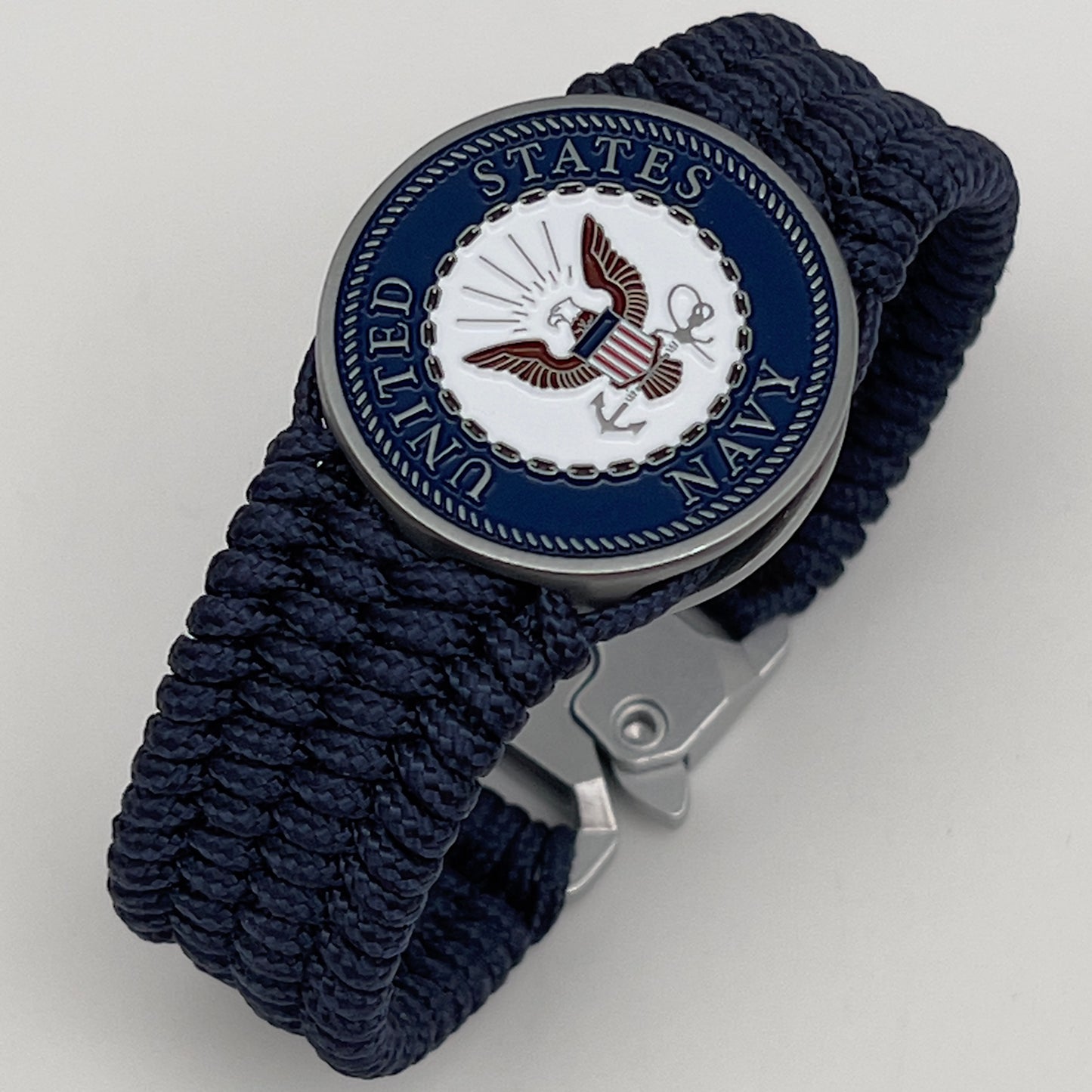 Thin, wide, flexible and comfortable braided United States Navy bracelet featuring an antique silver plated Navy medallion, a black Cobra style tactical buckle and woven with Navy Blue Type-1 paracord.