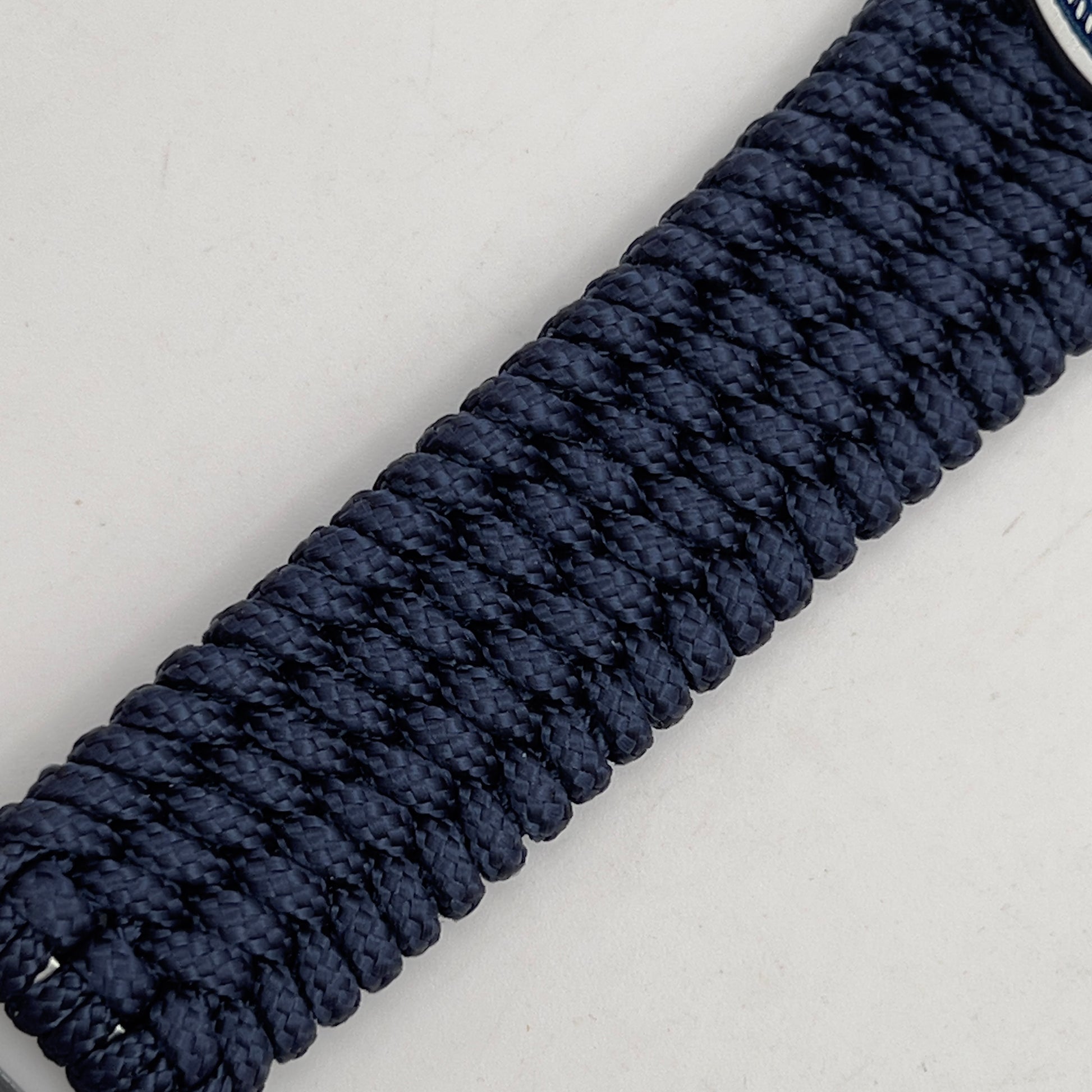 Thin, wide, flexible and comfortable braided United States Navy bracelet featuring an antique silver plated Navy medallion, a black Cobra style tactical buckle and woven with Navy Blue Type-1 paracord.