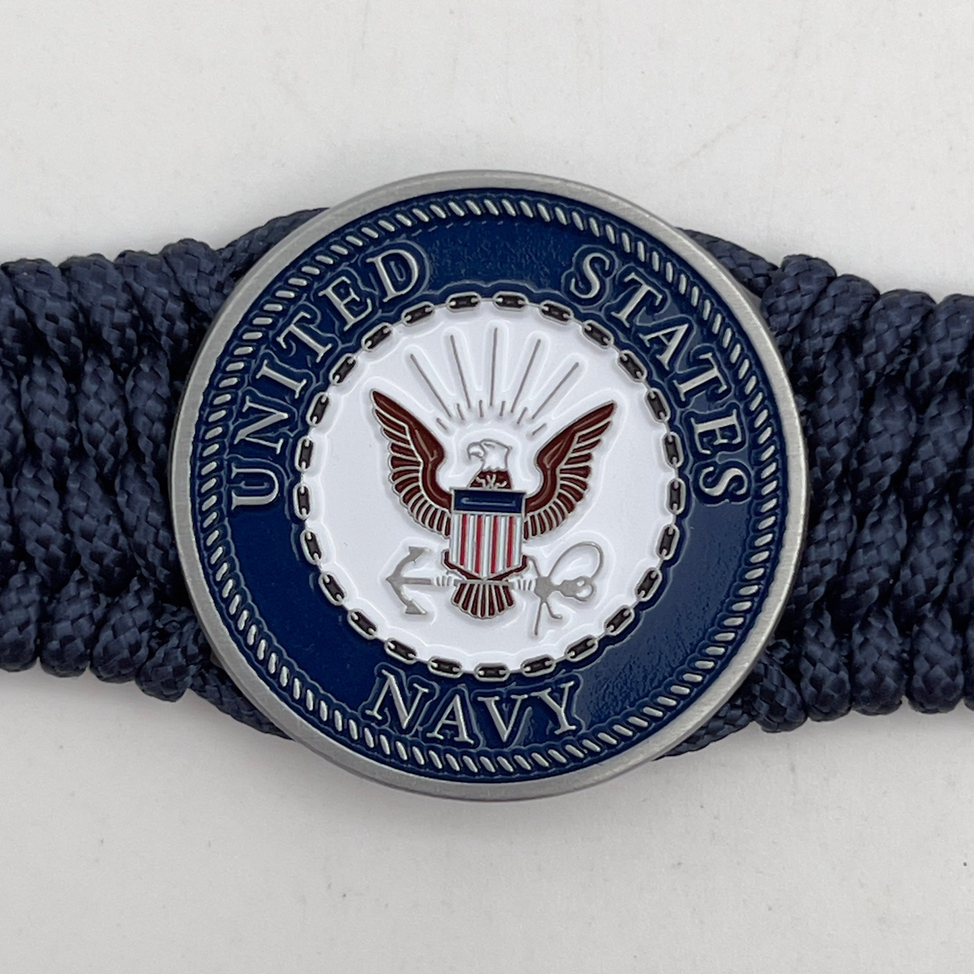 Thin, wide, flexible and comfortable braided United States Navy bracelet featuring an antique silver plated Navy medallion, a black Cobra style tactical buckle and woven with Navy Blue Type-1 paracord.