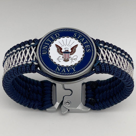 Thin, wide and comfortable braided United States Navy bracelet featuring an antique silver plated Navy medallion, a silver Cobra style tactical buckle and woven with Navy Blue Type-1 paracord and Nay Blue and White nano cord.