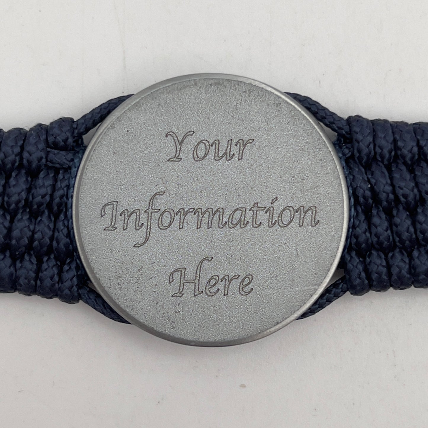 Thin, wide and comfortable braided United States Navy bracelet featuring an antique silver plated Navy medallion, a silver Cobra style tactical buckle and woven with Navy Blue Type-1 paracord and Nay Blue and White nano cord.