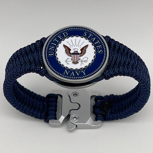 Thin, narrow, flexible and comfortable braided United States Navy bracelet featuring an antique silver plated Navy medallion, a silver Cobra style tactical buckle and woven with Navy Blue Type-1 paracord.