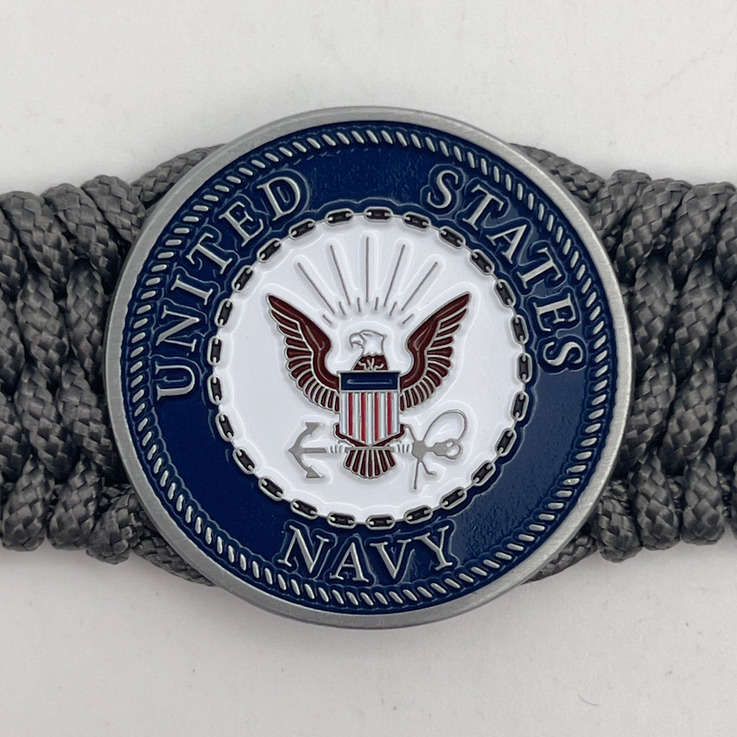 Thin, wide, flexible and comfortable braided United States Navy bracelet featuring an antique silver plated Navy medallion, a silver Cobra style tactical buckle and woven with Charcoal Gray Type-1 paracord.