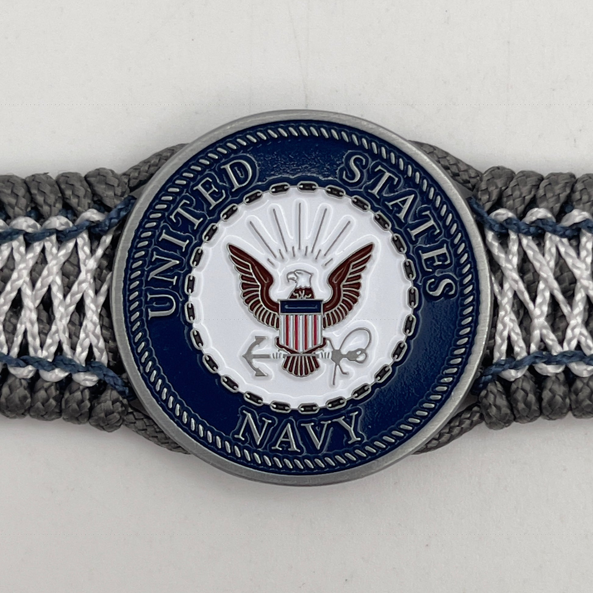 Thin, wide and comfortable braided United States Navy bracelet featuring an antique silver plated Navy medallion, a silver Cobra style tactical buckle and woven with Charcoal Gray Type-1 paracord and Nay Blue and White nano cord.