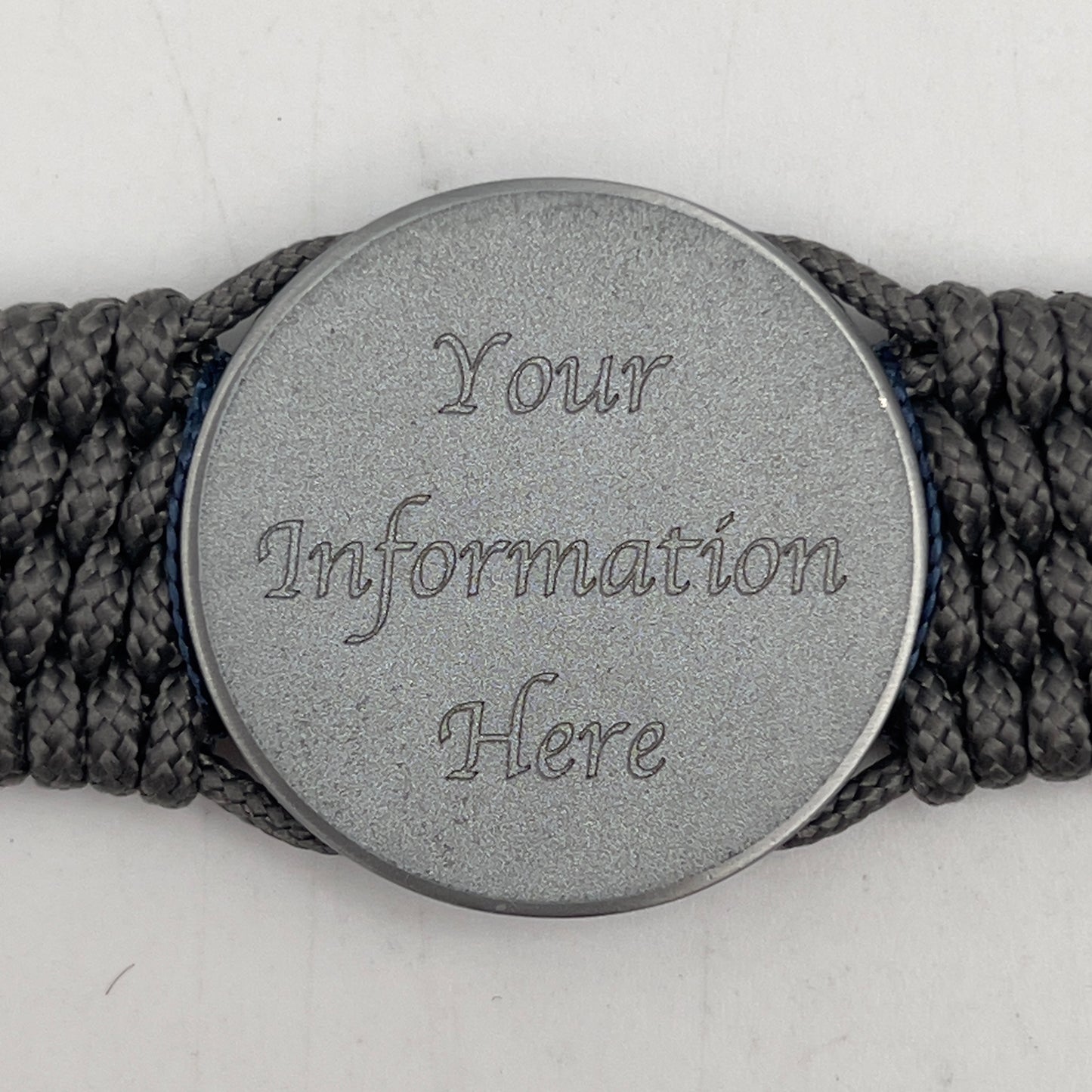 Thin, wide and comfortable braided United States Navy bracelet featuring an antique silver plated Navy medallion, a silver Cobra style tactical buckle and woven with Charcoal Gray Type-1 paracord and Nay Blue and White nano cord.