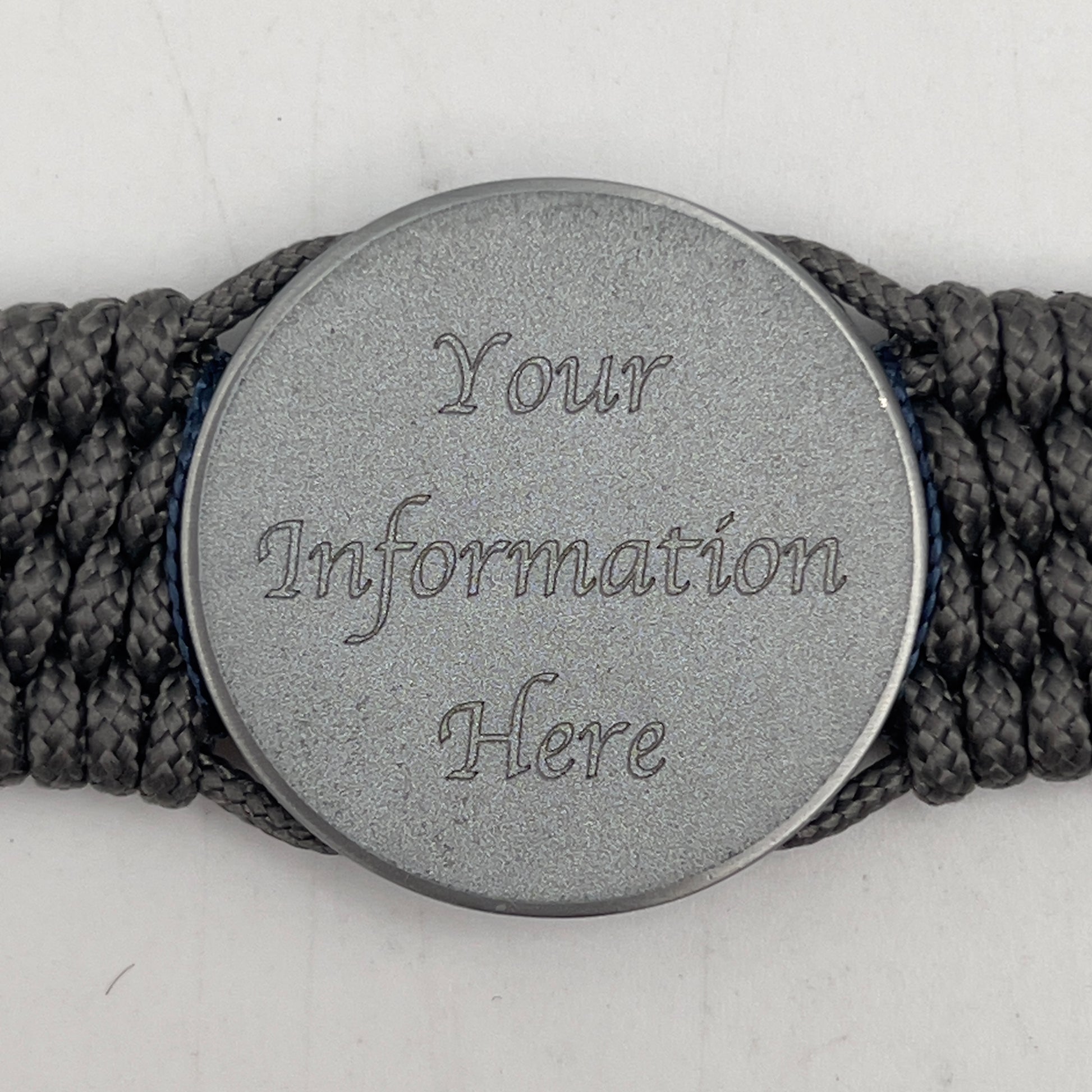 Thin, wide and comfortable braided United States Navy bracelet featuring an antique silver plated Navy medallion, a silver Cobra style tactical buckle and woven with Charcoal Gray Type-1 paracord and Nay Blue and White nano cord.