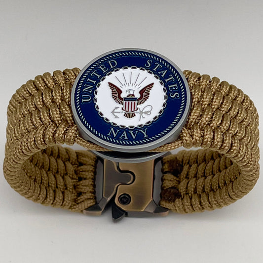 Thin, wide, flexible and comfortable braided United States Navy bracelet featuring an antique silver plated Navy medallion, a gold Cobra style tactical buckle and woven with gold Type-1 paracord.
