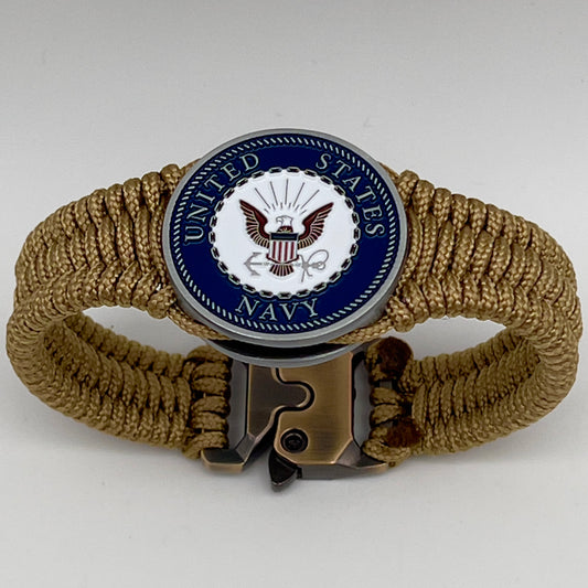 Thin, narrow, flexible and comfortable braided United States Navy bracelet featuring an antique silver plated Navy medallion, a gold Cobra style tactical buckle and woven with gold Type-1 paracord.